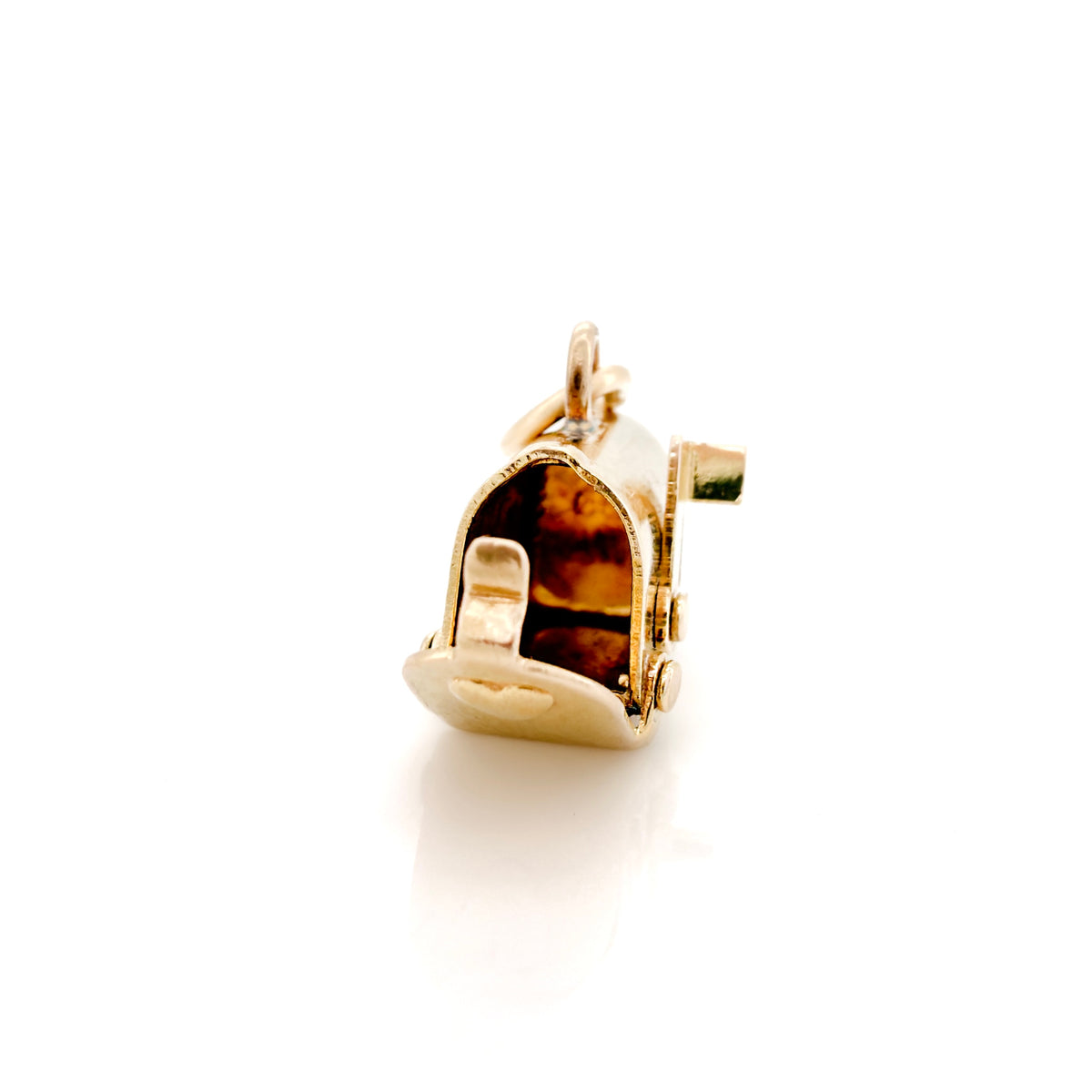 A gold charm shaped like a mailbox with an open door, on a clean white background with a soft reflection below.