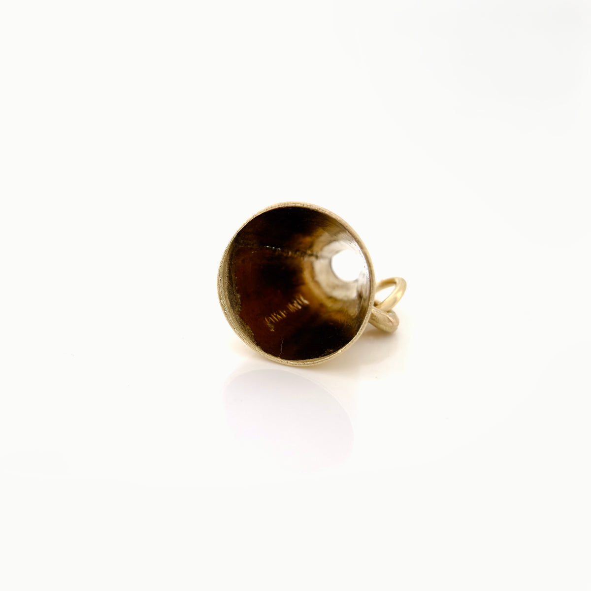 A gold megaphone charm opening, photographed on a clean white background.
