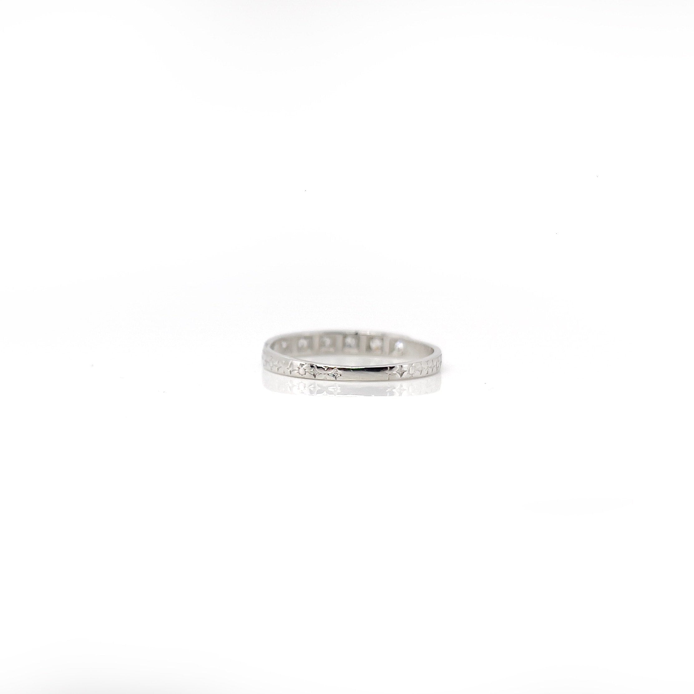 Art deco 7 single cut diamond platinum wedding band against a white background.