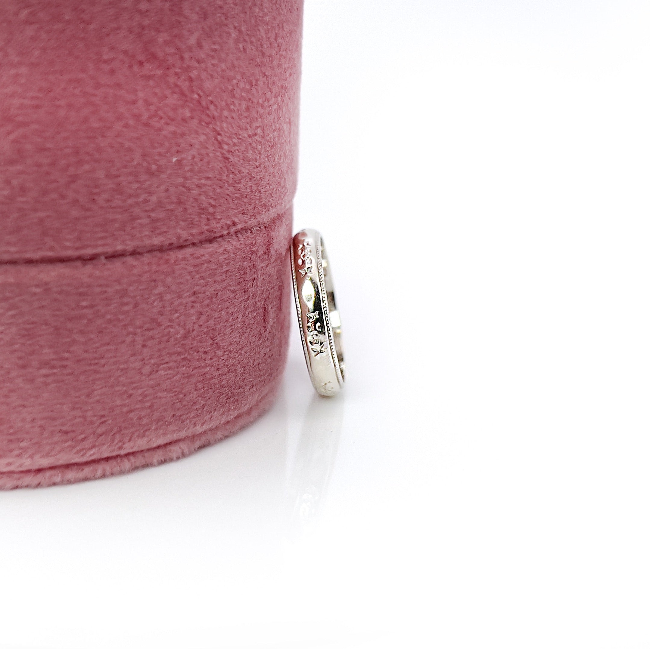 A vintage white gold ring with faint orange blossom design and milgrain pattern, size 5.25, with an inscription.