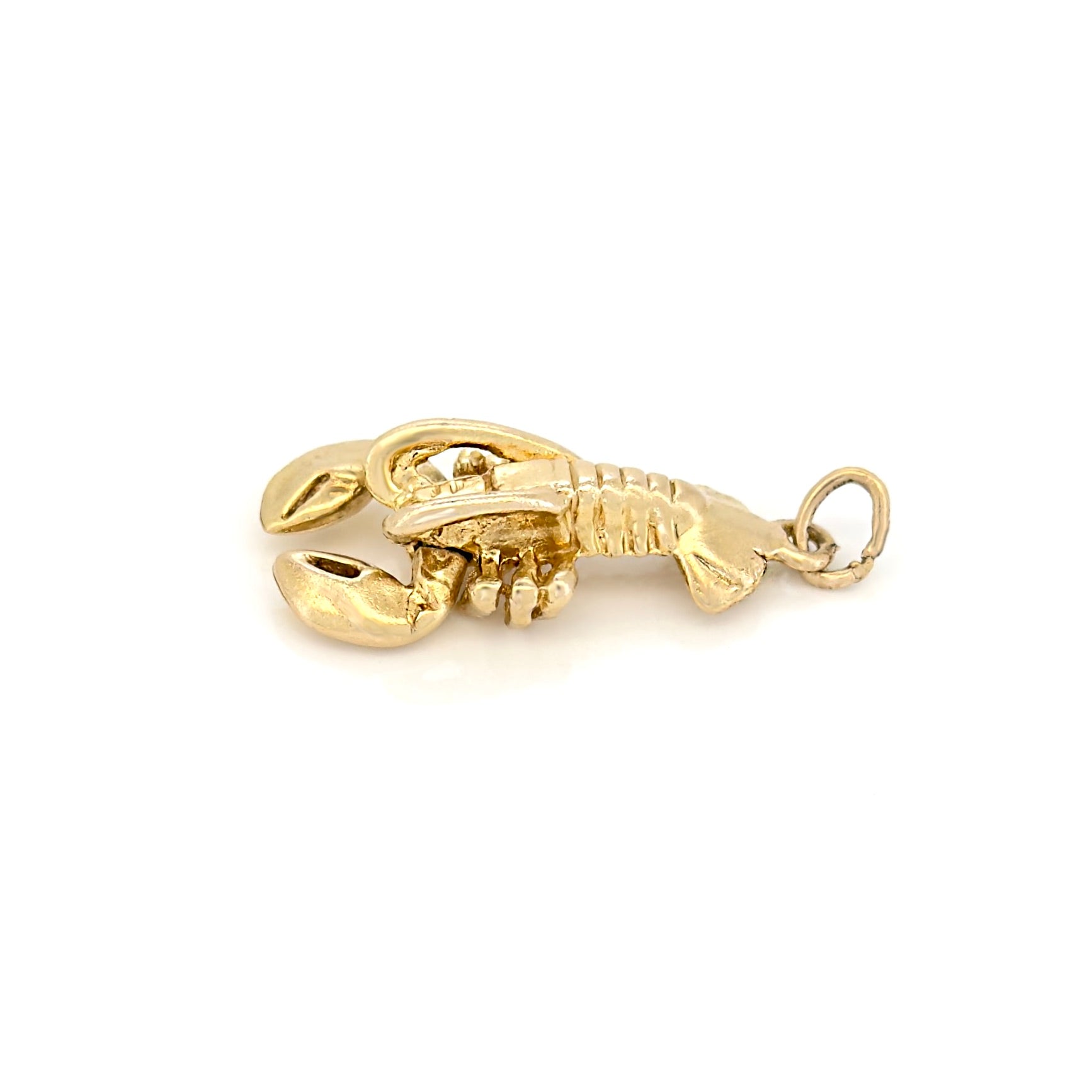 Gold lobster charm on a white background