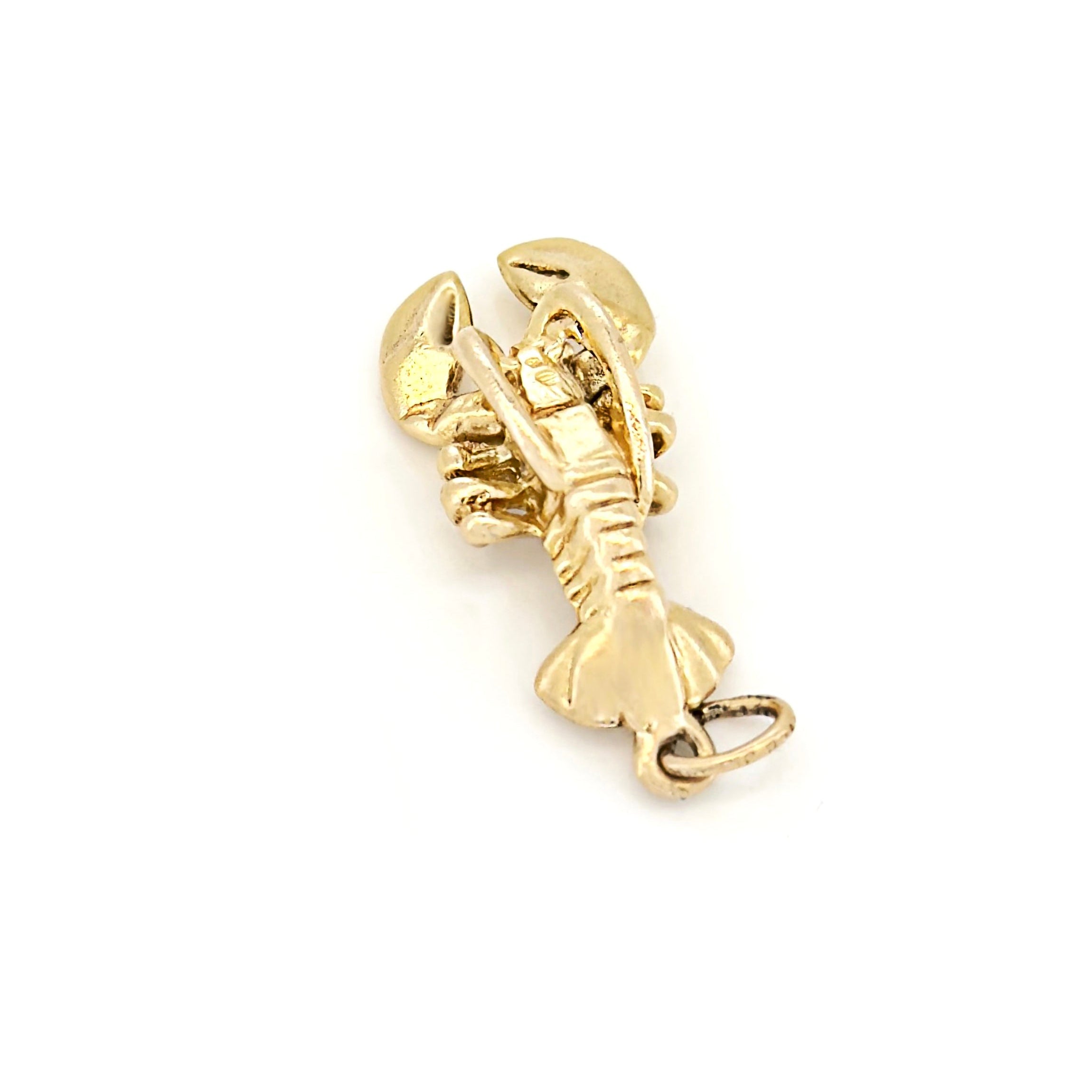 Gold lobster charm on a white background