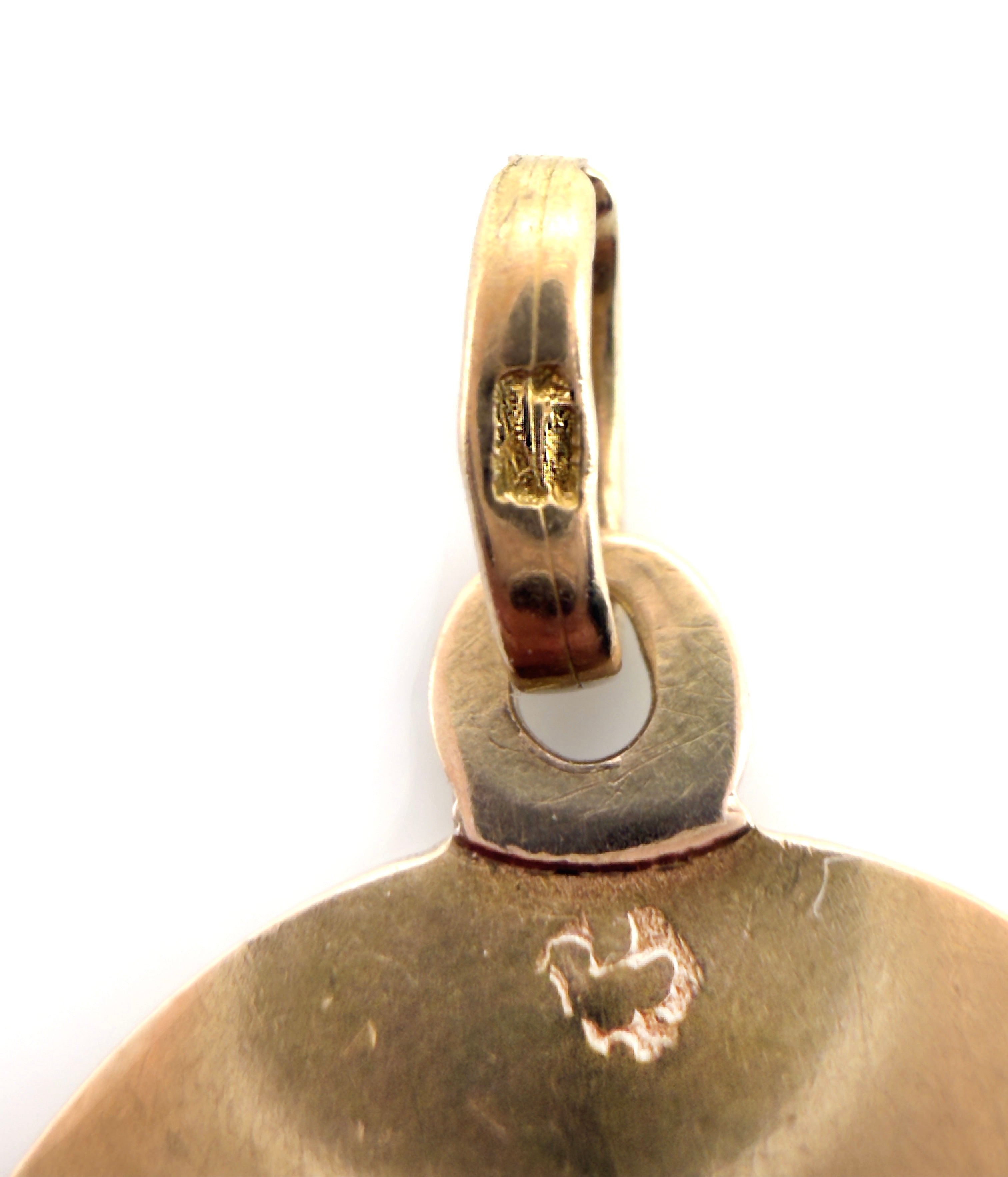 Gold pendant with a small cutout design on a white background