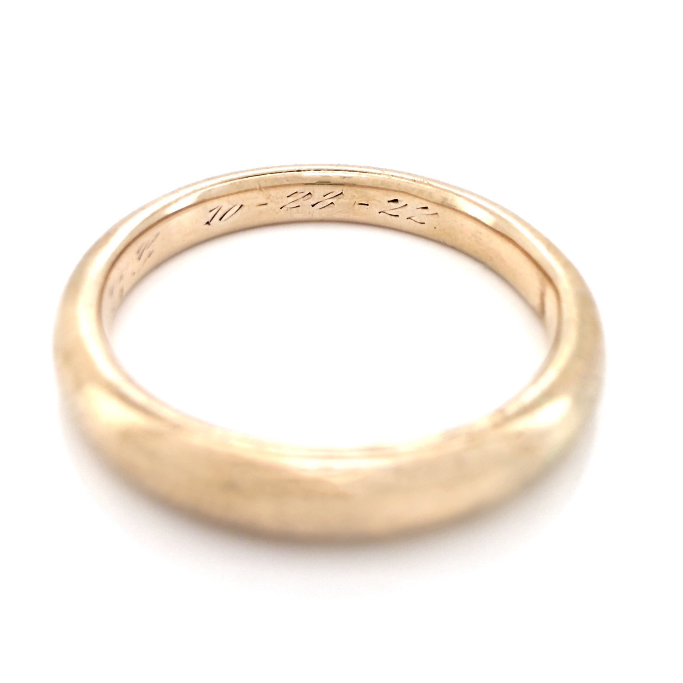 Antique gold ring with an inscription on a white background