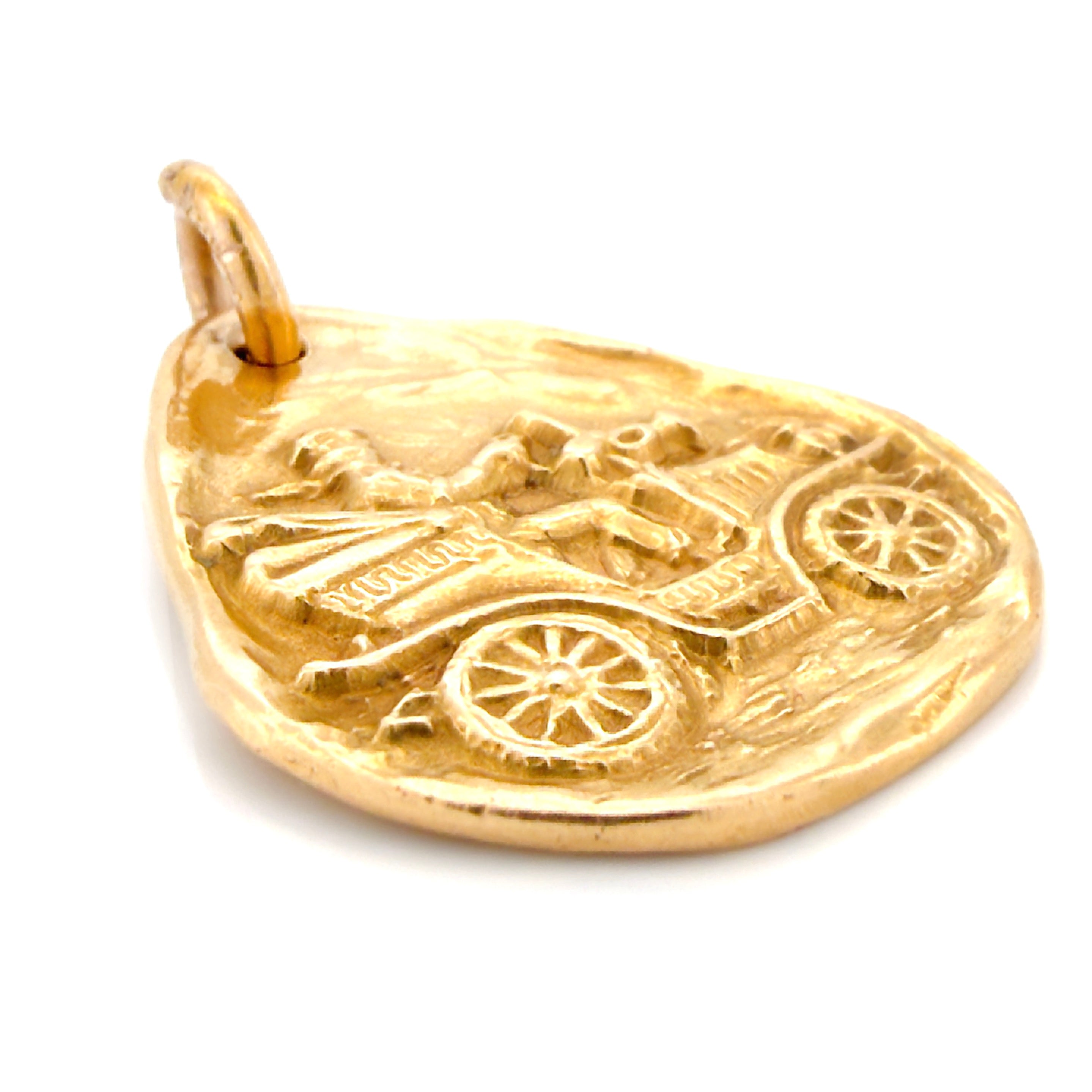 Gold pendant with vintage car design on a white background.