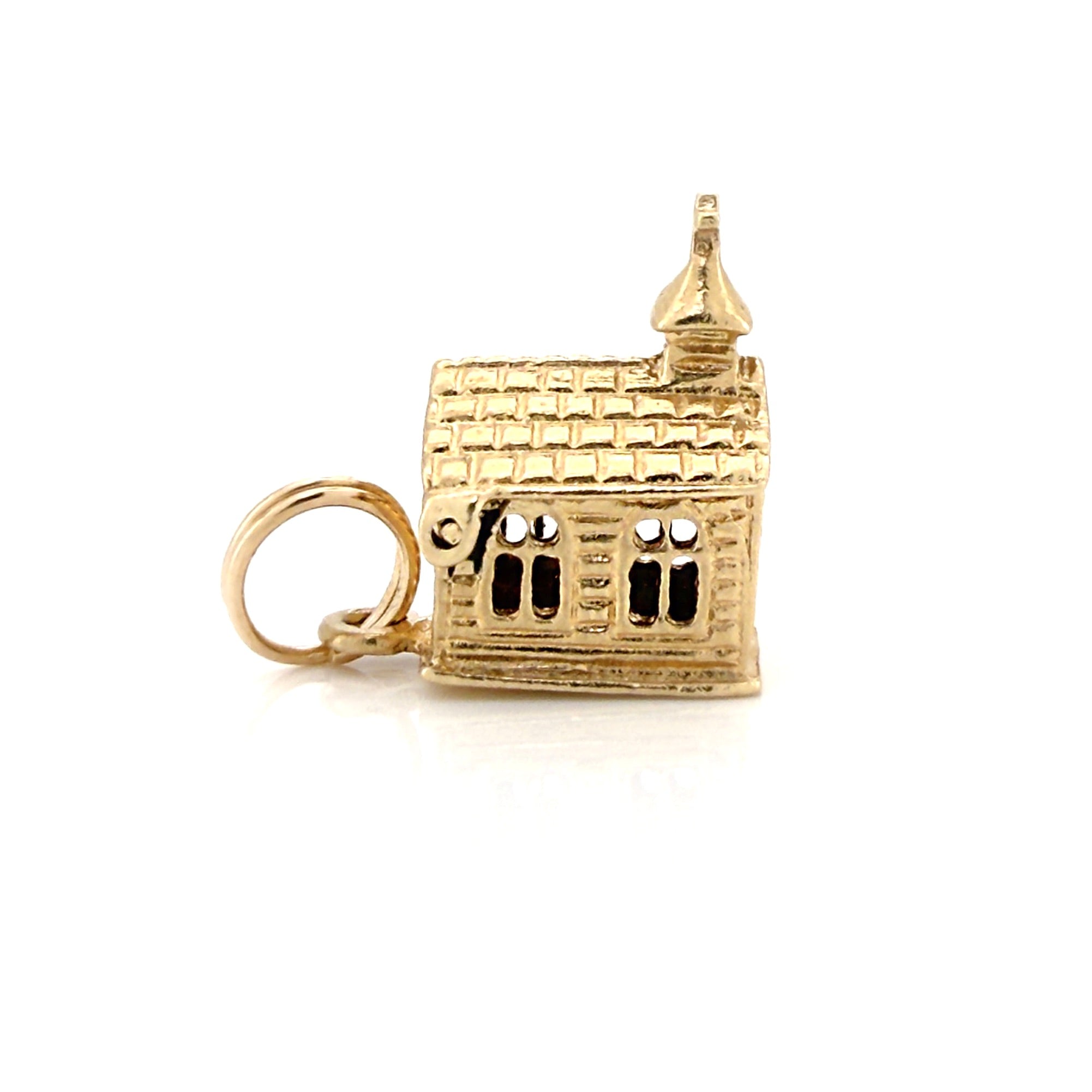 Vintage gold miniature chapel charm on a white background