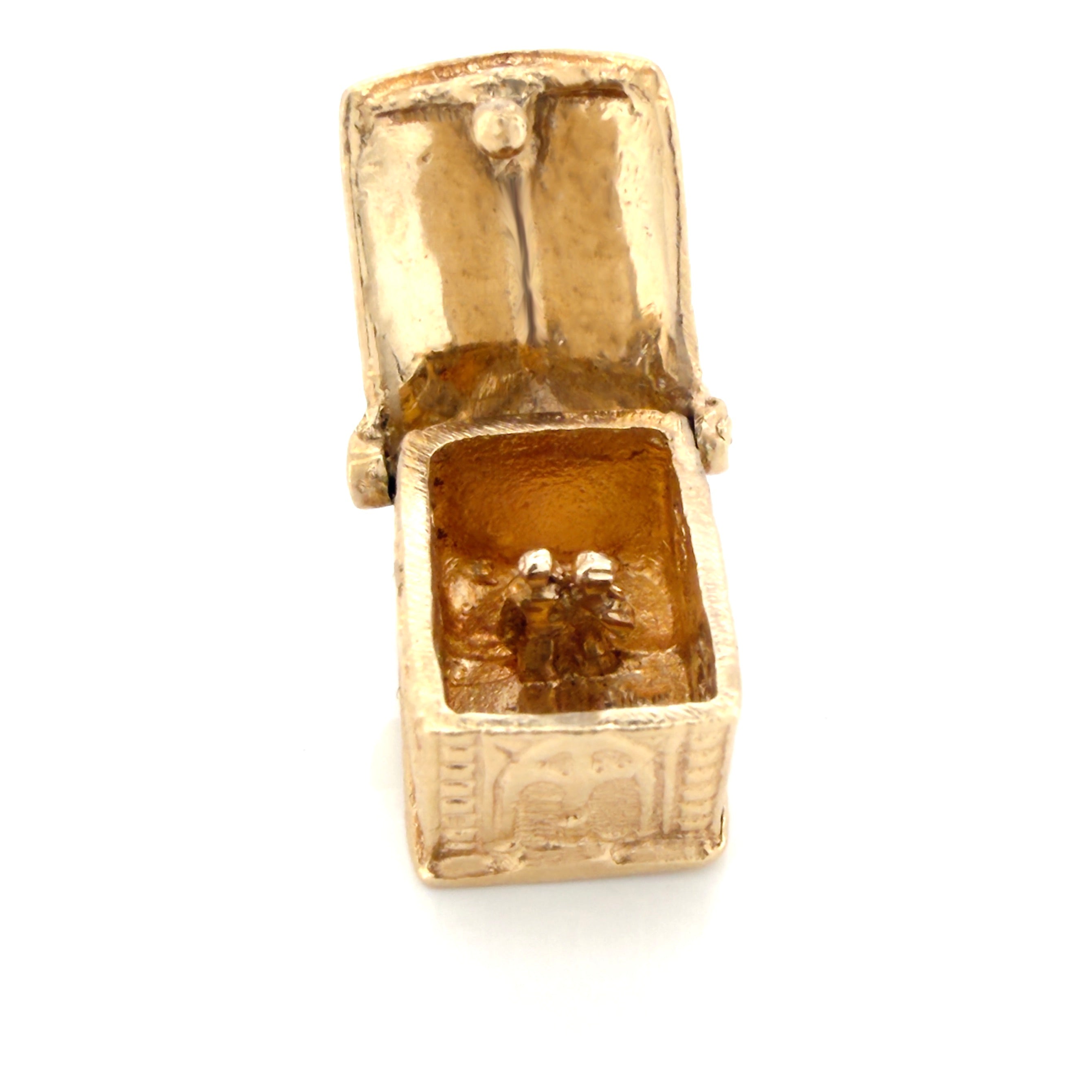 Vintage gold miniature chapel charm with a couple inside on a white background