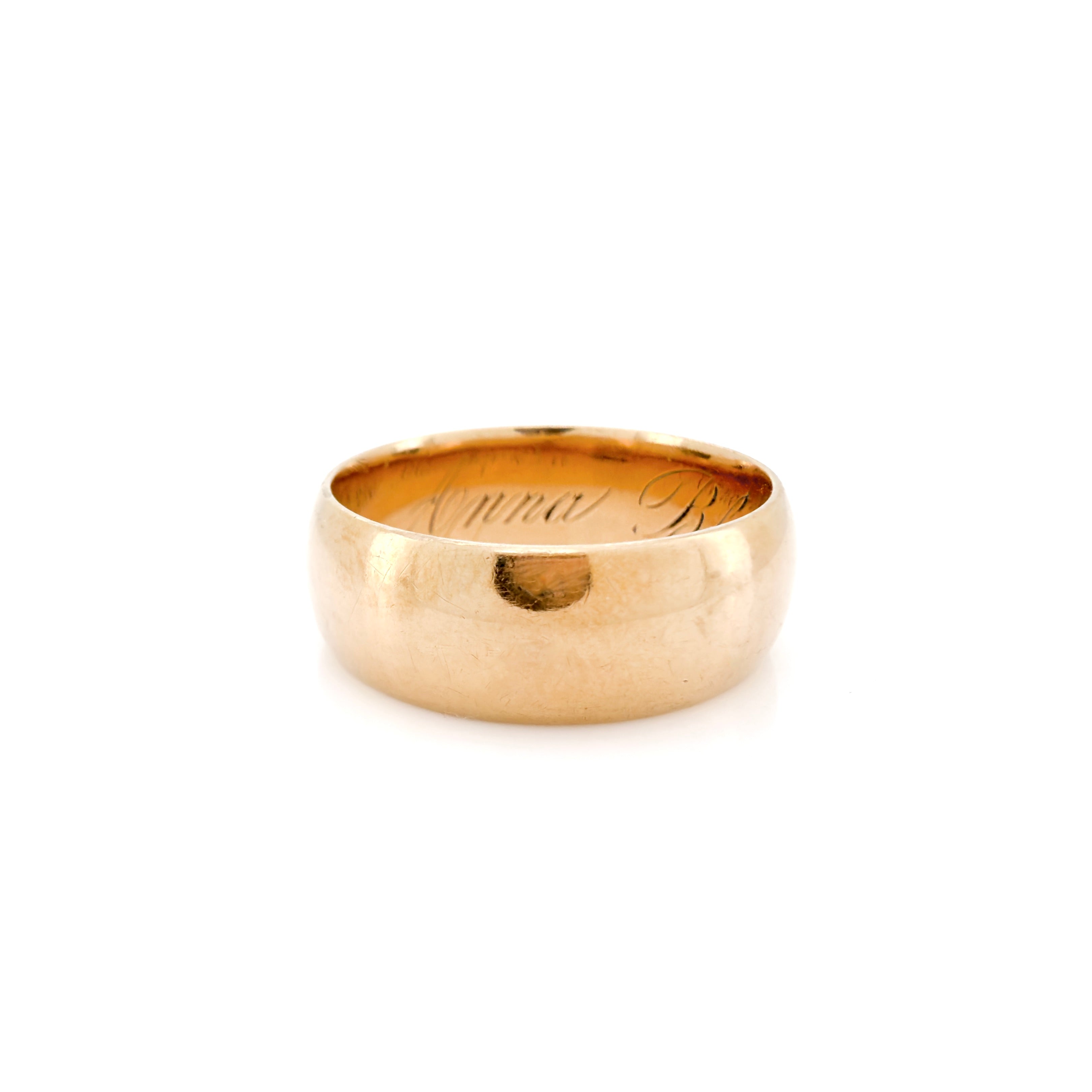 A classic Victorian yellow gold band ring with a smooth, polished finish and a custom engraving inside, shown on a clean white background.