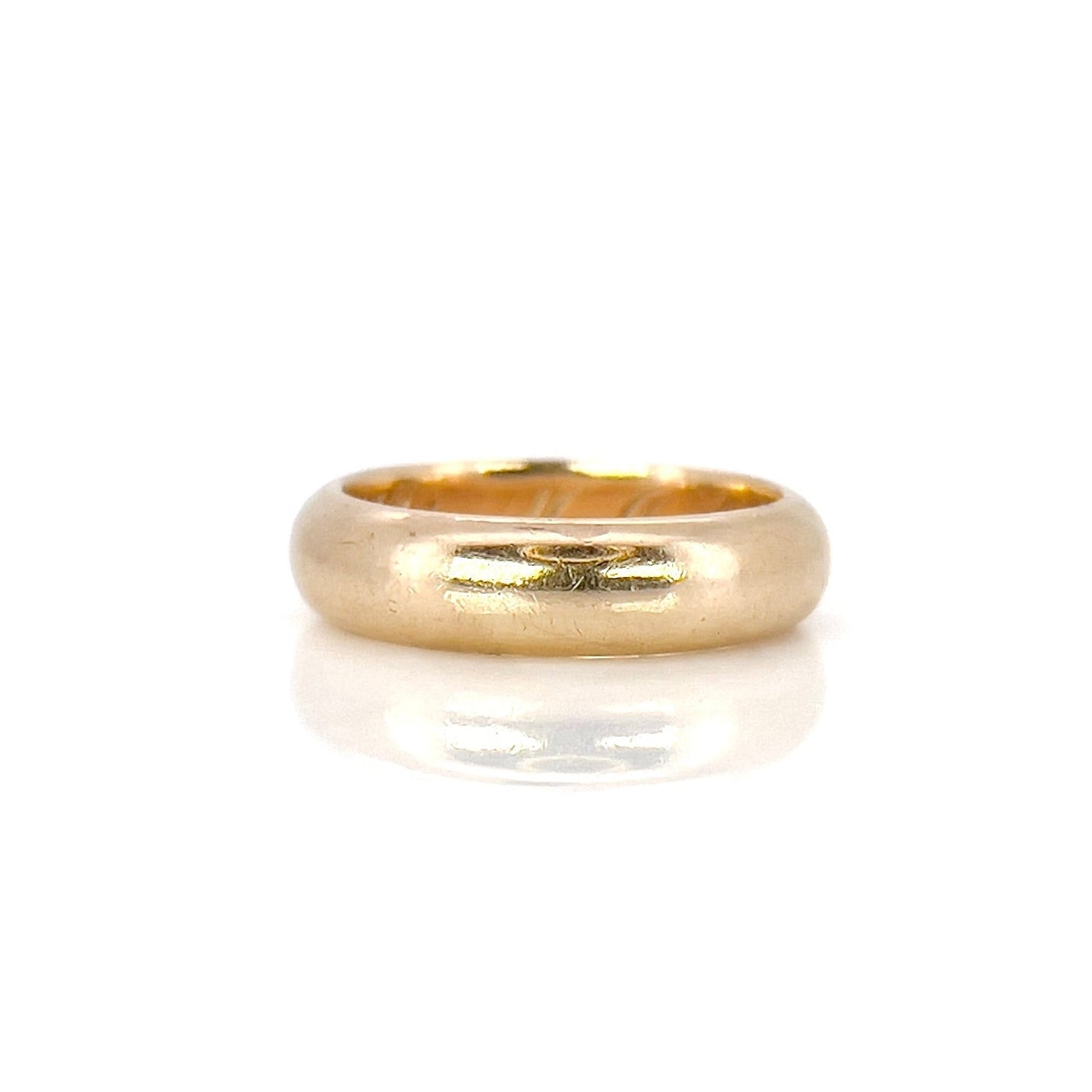 An antique gold band with an inscription, displayed against a white background.