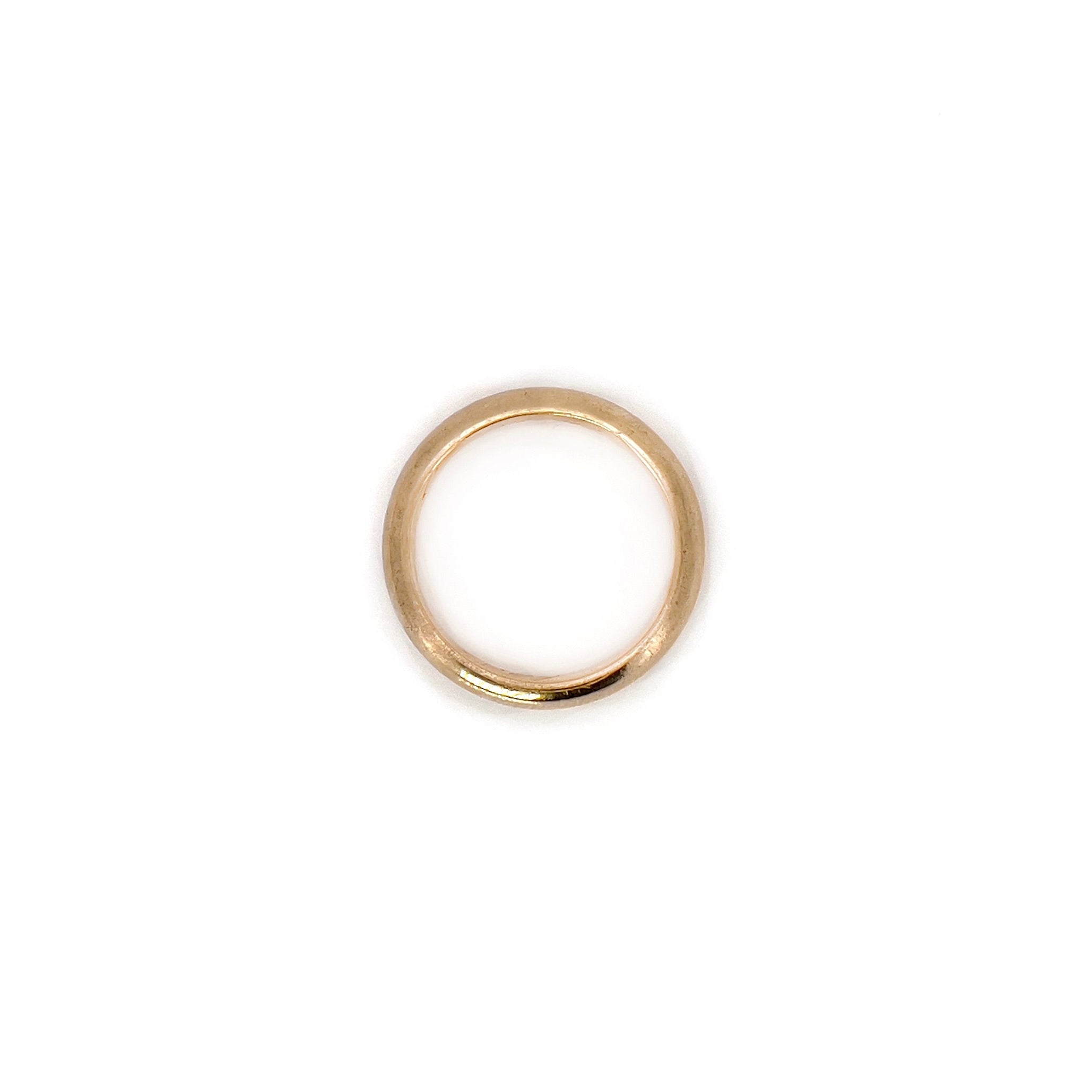 An antique gold band with an inscription, displayed against a white background.