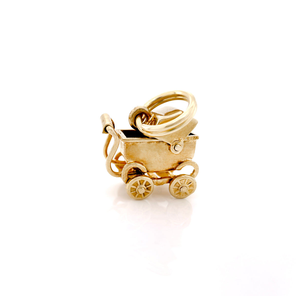 A gold baby stroller charm, featuring a canopy, wheels, and a ring attachment, shown on a clean white background.