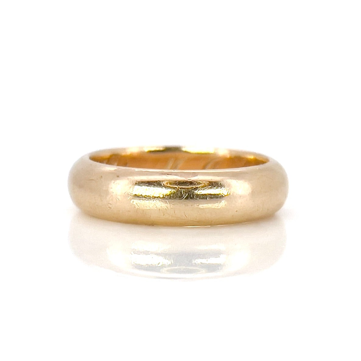 An antique gold band with an inscription, displayed against a white background.