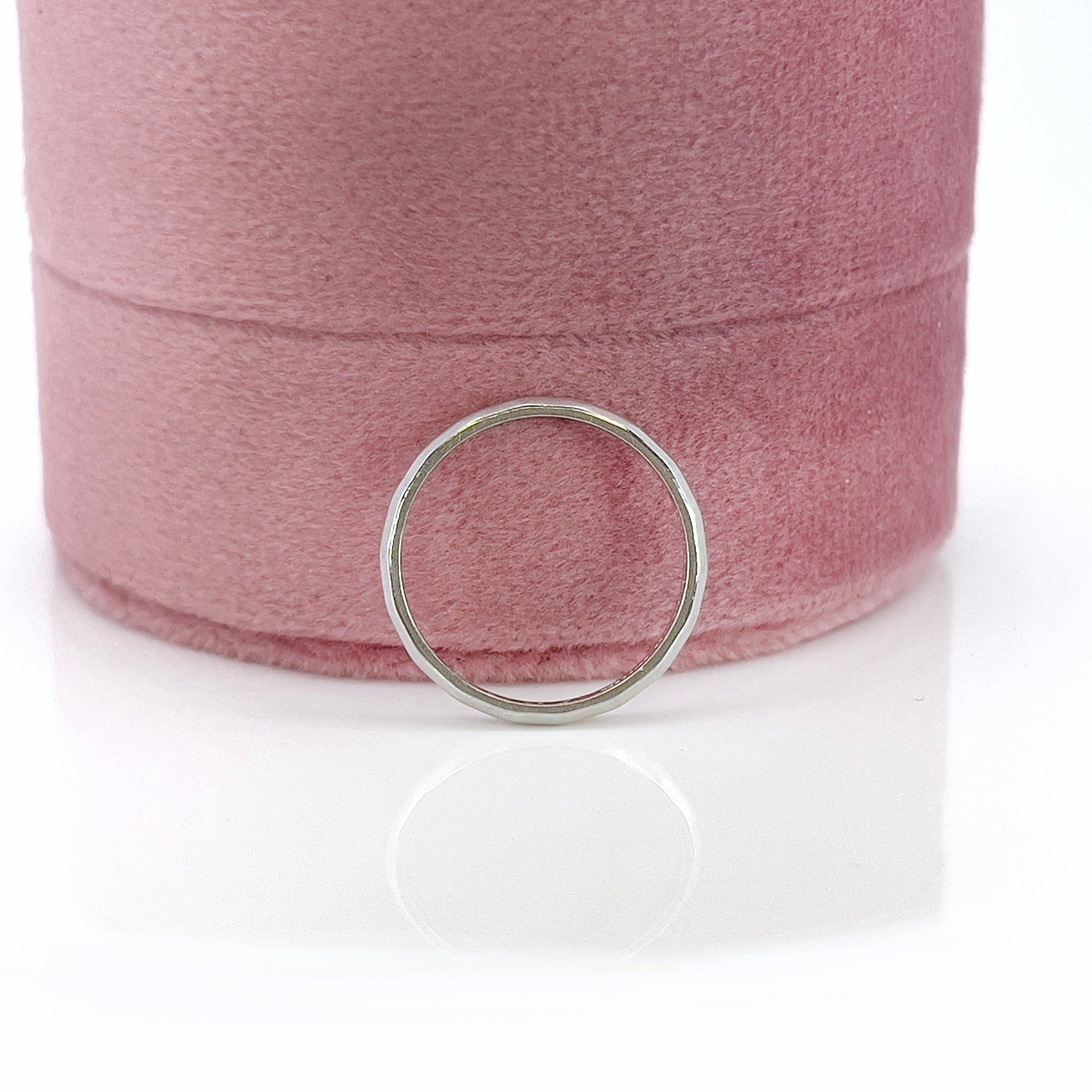 A vintage platinum ring with art carved design, showing visible wear and an inscription on the inside.