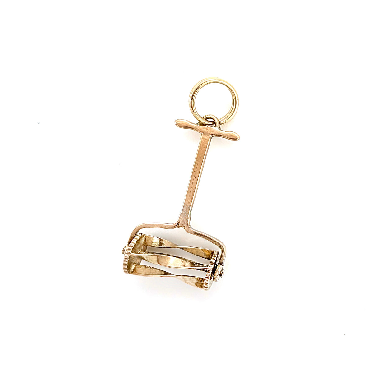 A small gold hand push lawn mower charm with a circular loop at the top and a basket-like openwork lower section, on a plain white background.