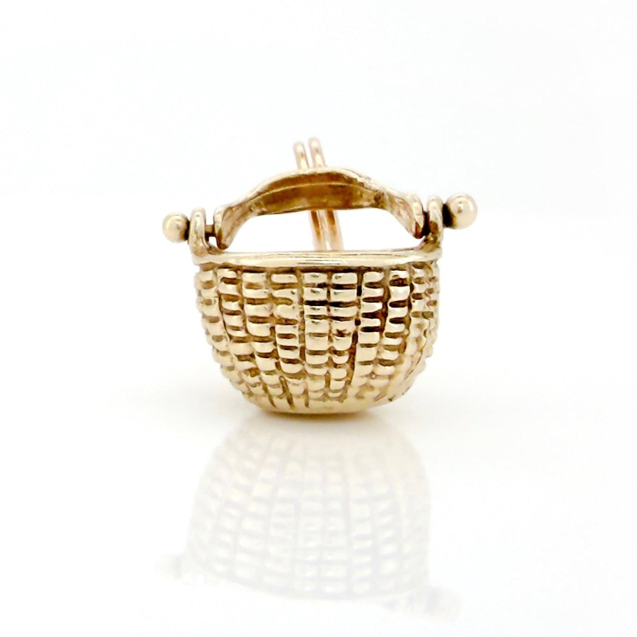 Gold basket-shaped earring on a white background
