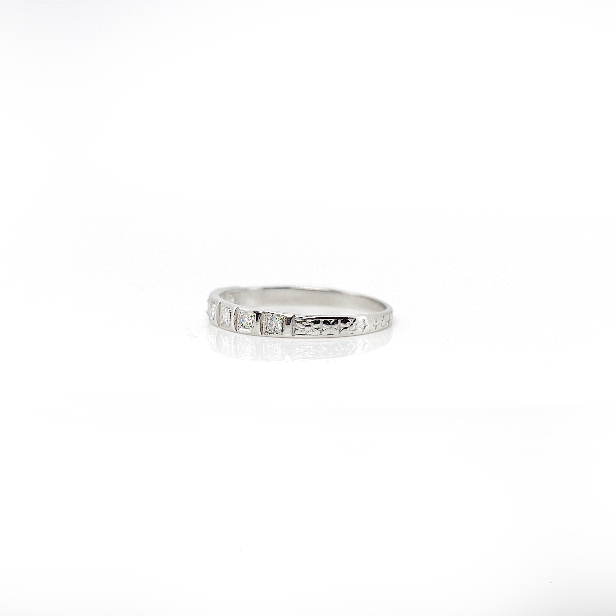 Art deco 7 single cut diamond platinum wedding band against a white background. 