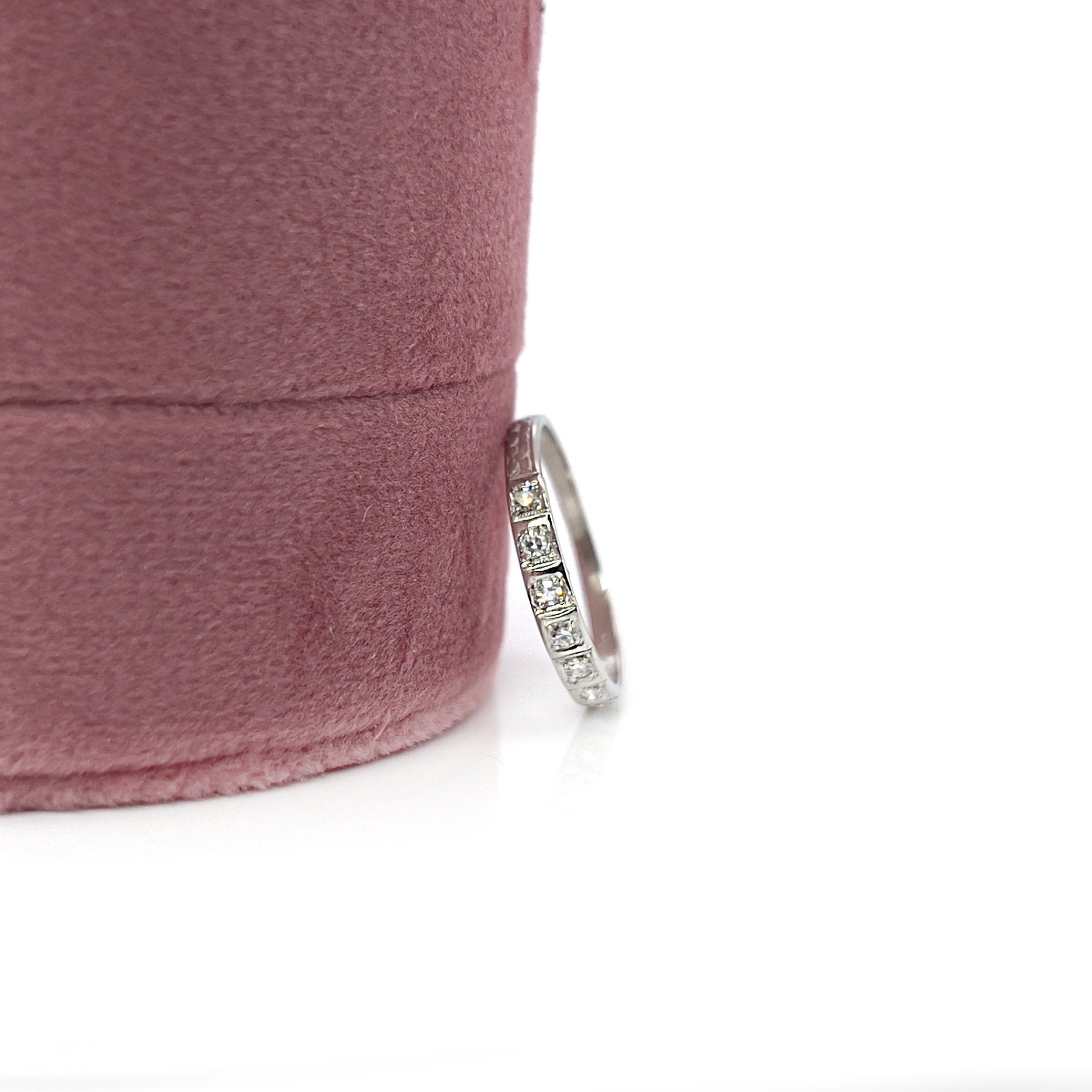 Art deco 7 single cut diamond platinum wedding band against a white background. 