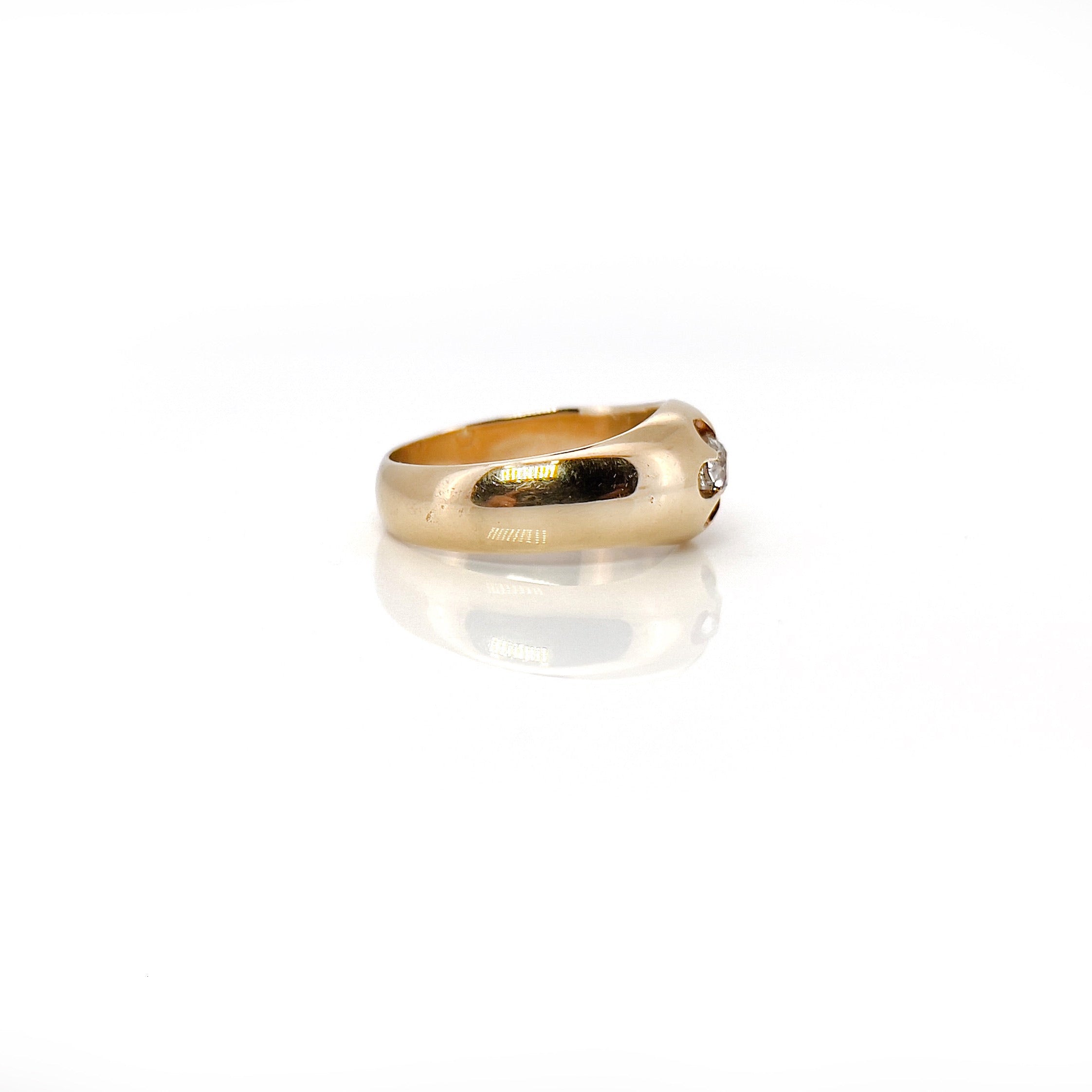 Antique 14K gold diamond ring with a central old European cut diamond, surrounded by a flower-like setting, with a rosy patina.