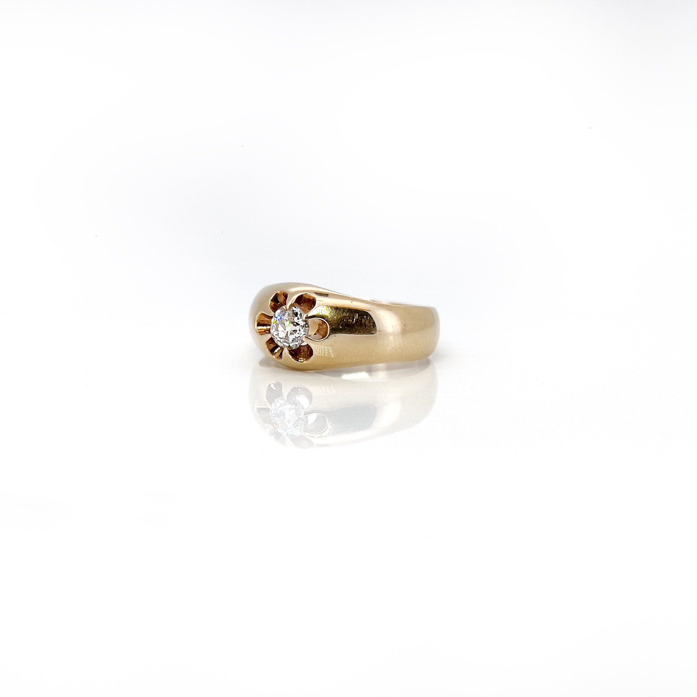 Antique 14K gold diamond ring with a central old European cut diamond, surrounded by a flower-like setting, with a rosy patina.