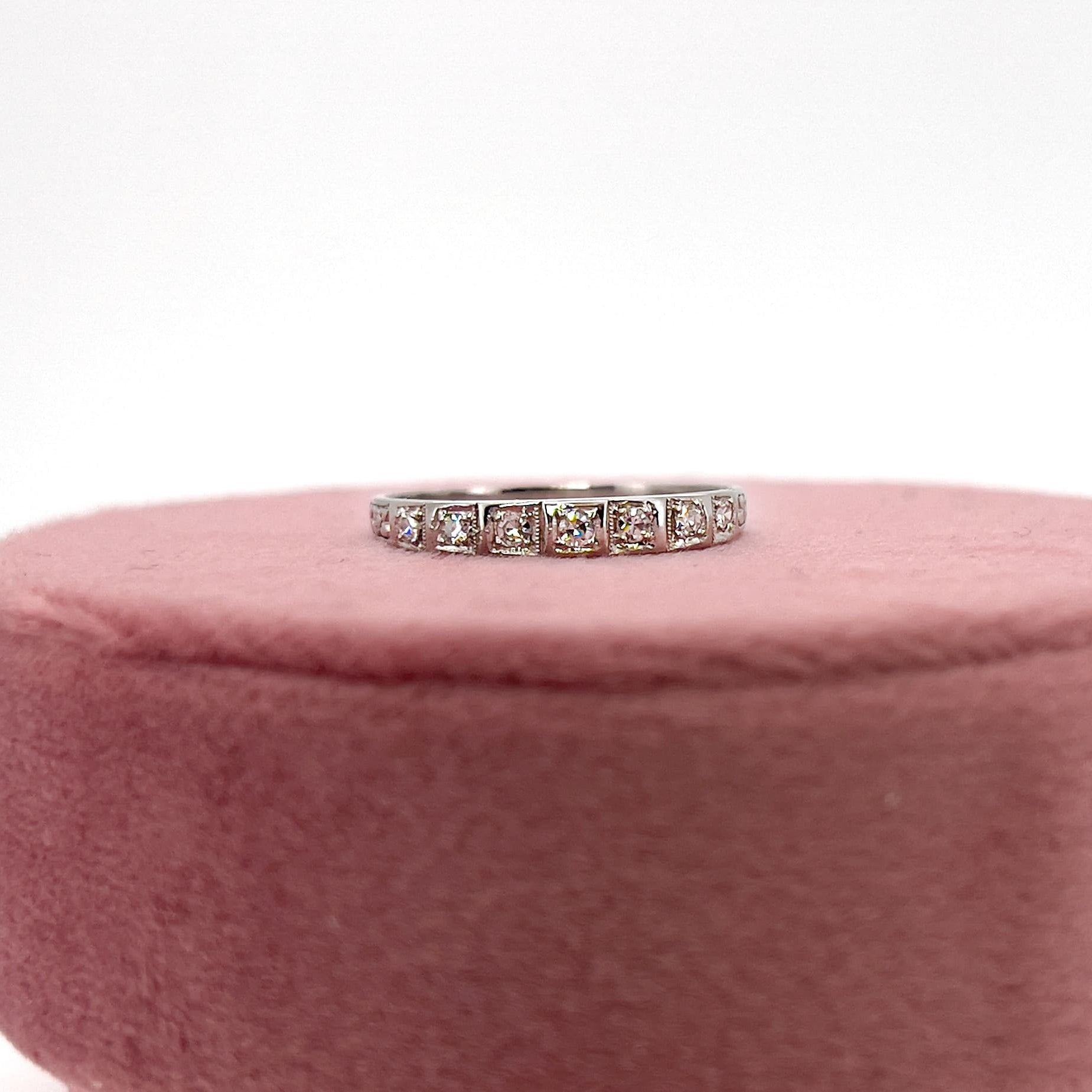 Art deco 7 single cut diamond platinum wedding band against a white background. 