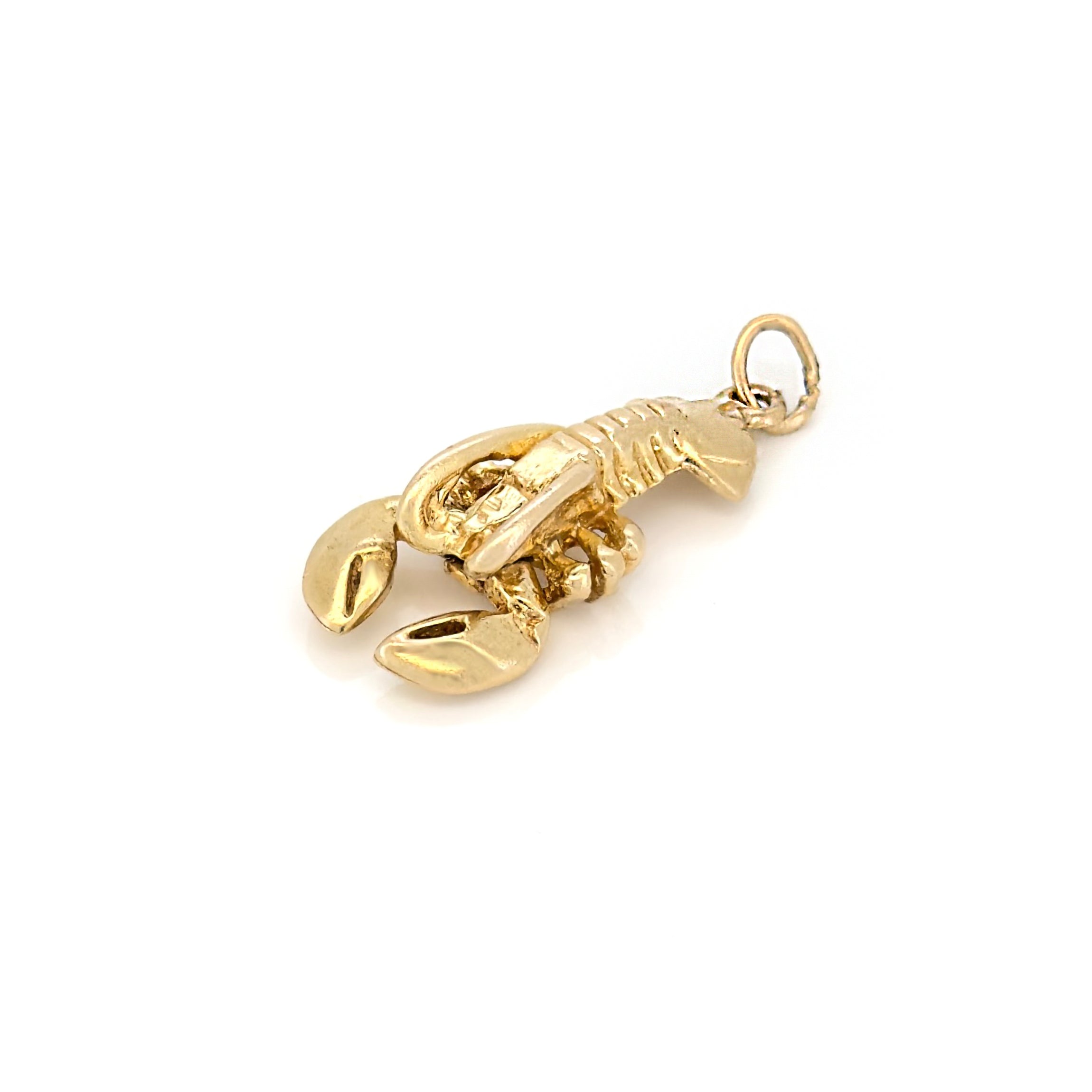 Gold lobster charm on a white background