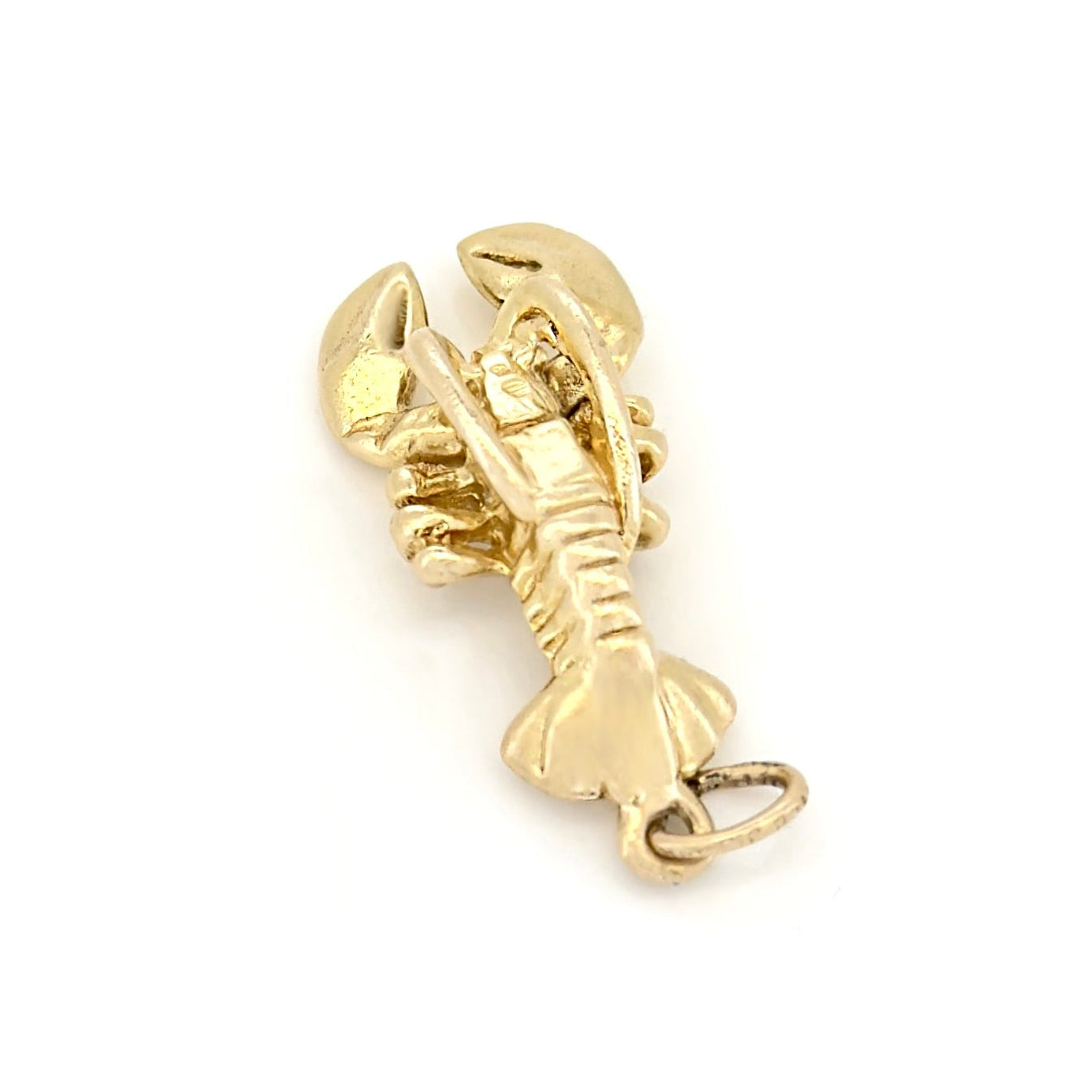 Gold lobster charm on a white background