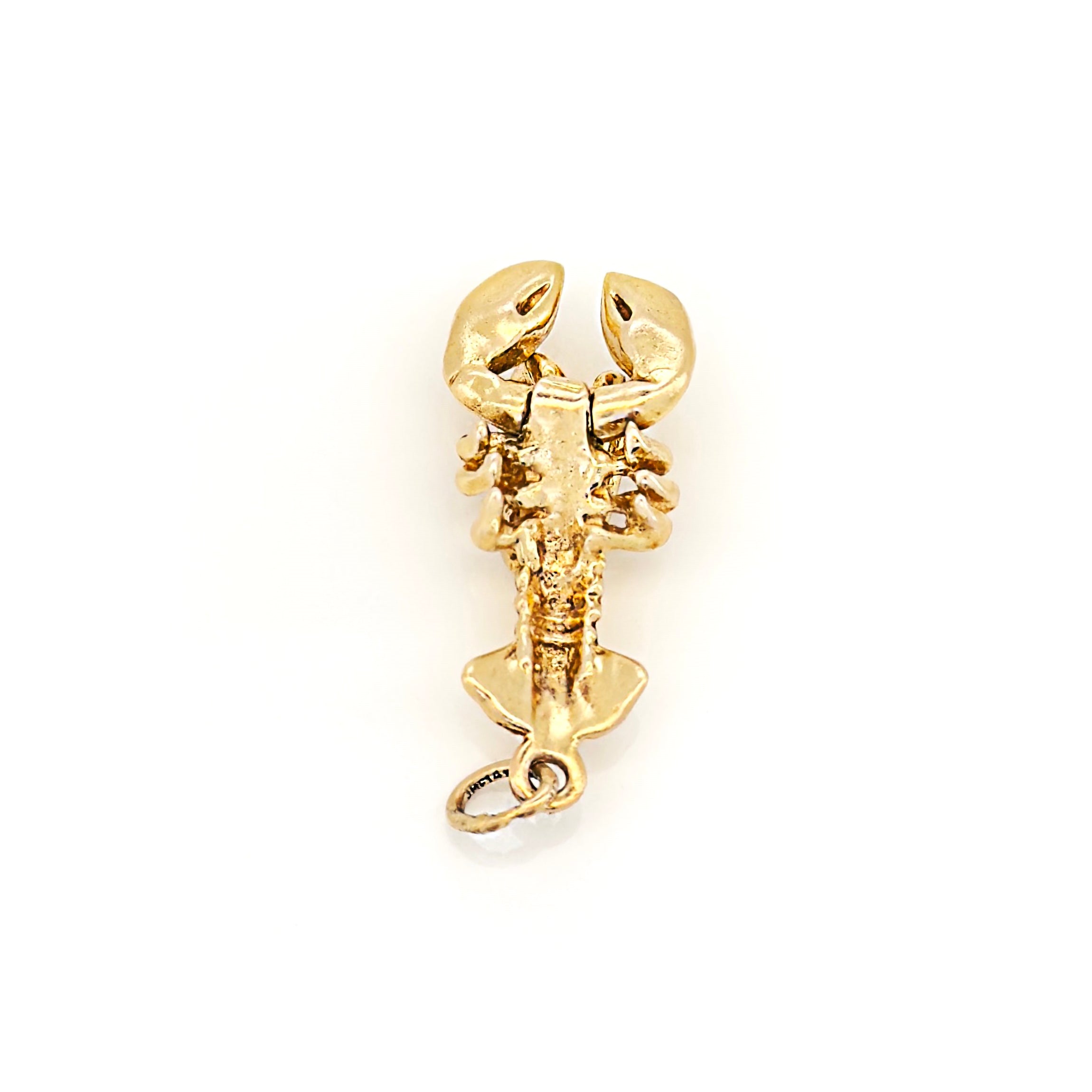 Gold lobster charm on a white background
