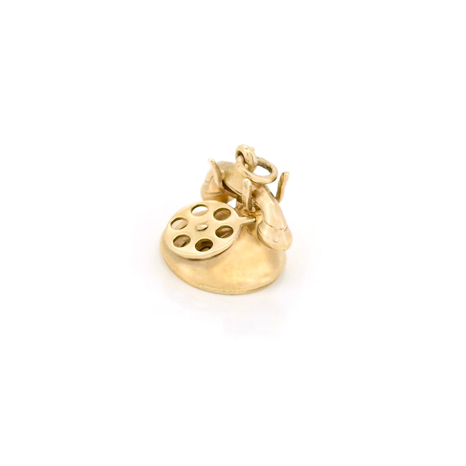 Gold charm shaped like a phone on a white background