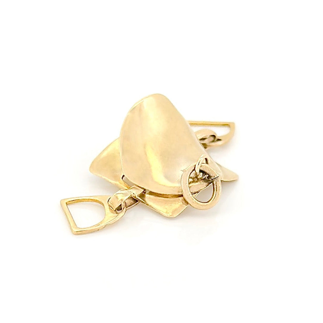 Gold saddle charm on a white background