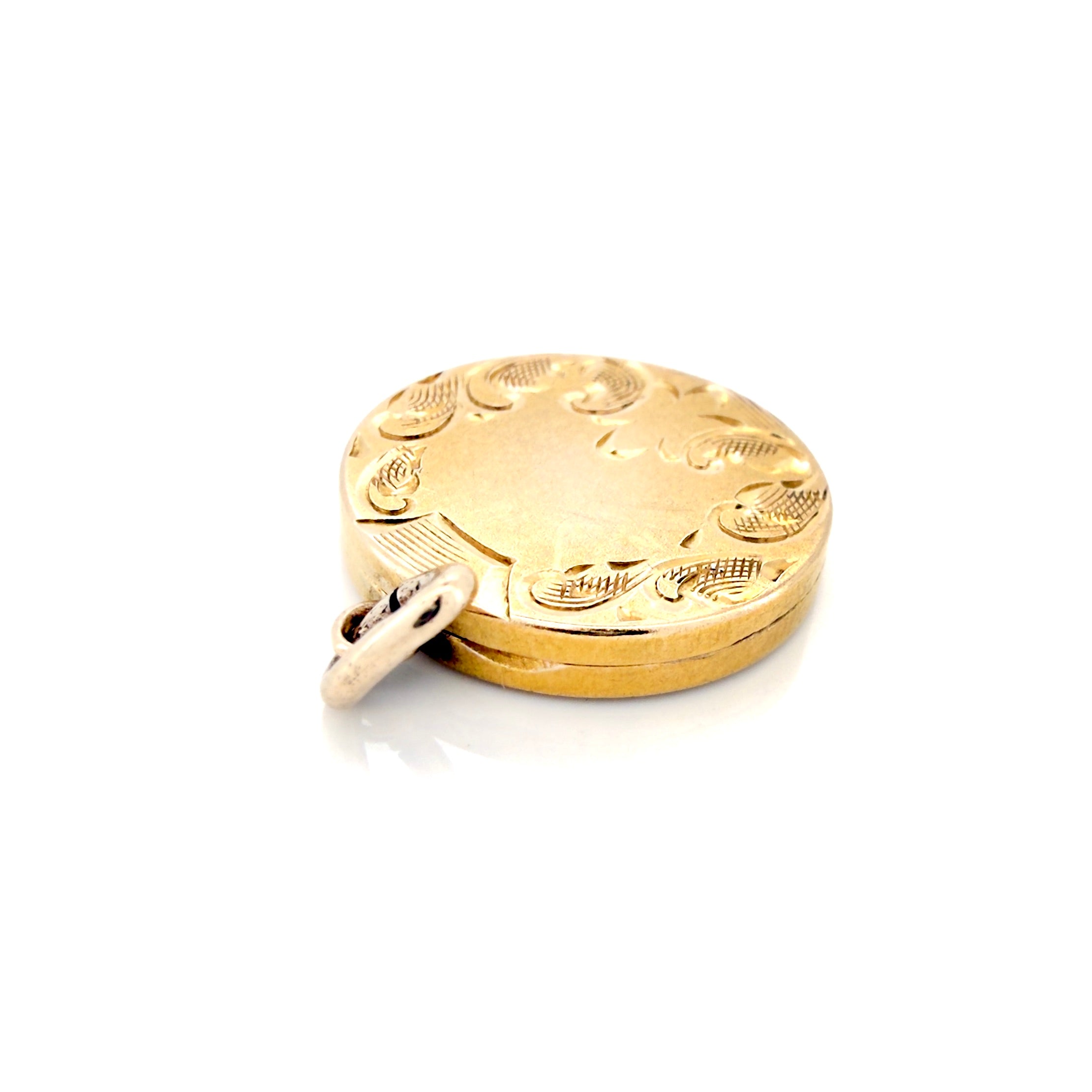 Gold locket with engraved design on a white background