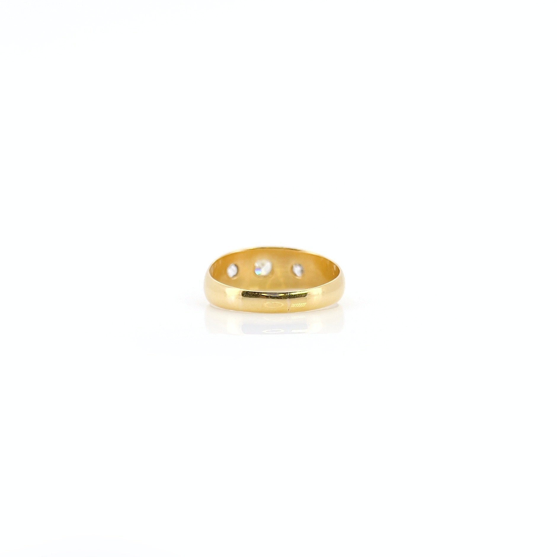 A 22K gold old mine cut diamond celestial ring with three visible diamonds.