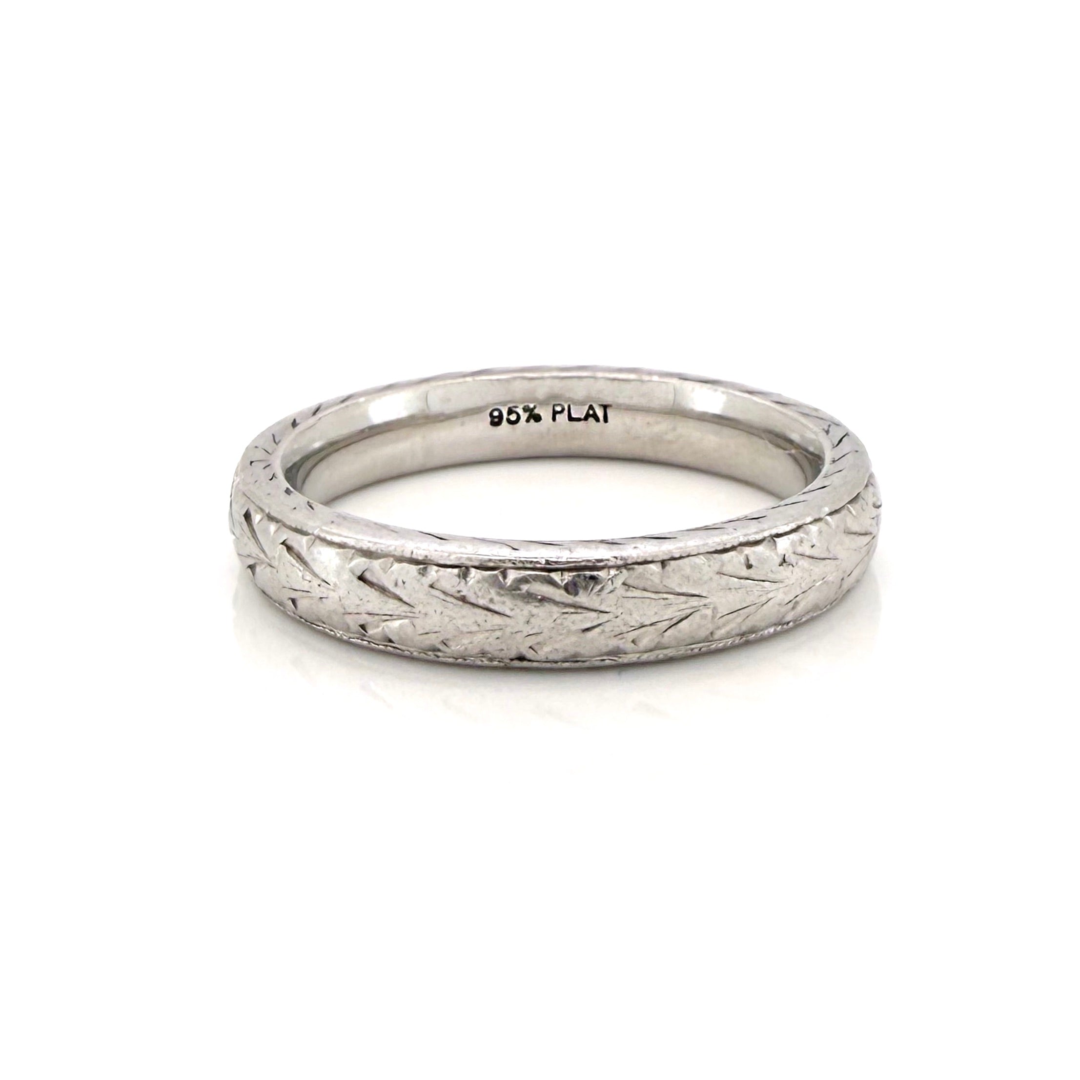 Vintage platinum ring with textured design and a '95% PLAT' stamp on a white background