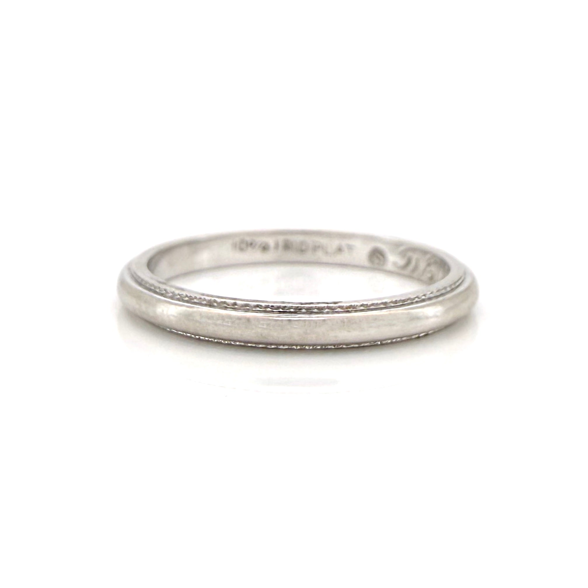 vintage silver ring with fine milgrain on a white background