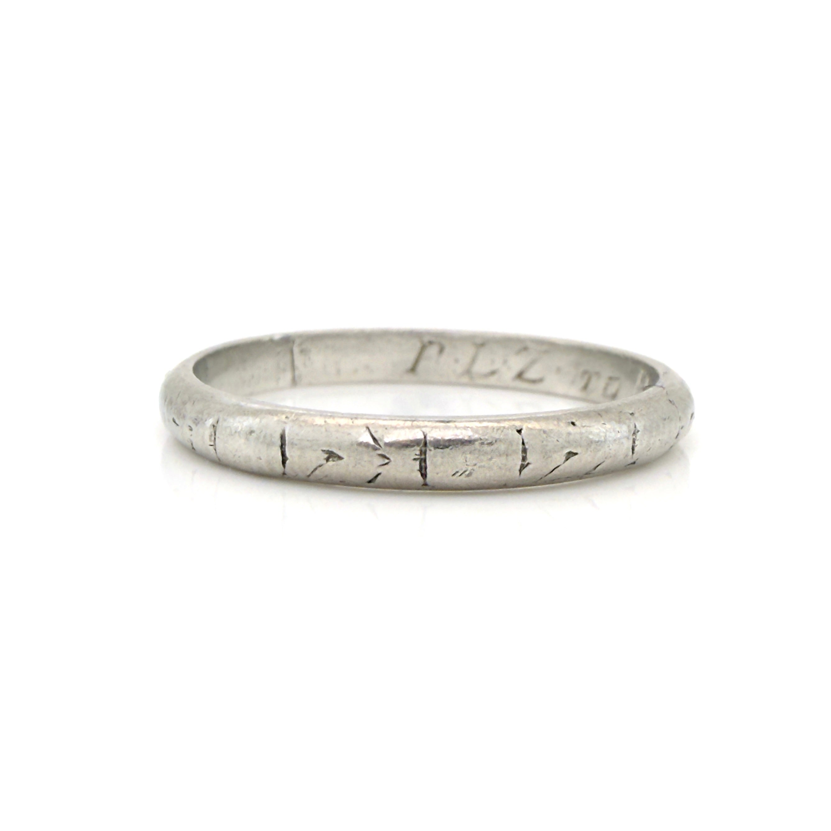 Art Deco platinum ring with textured design on a white background