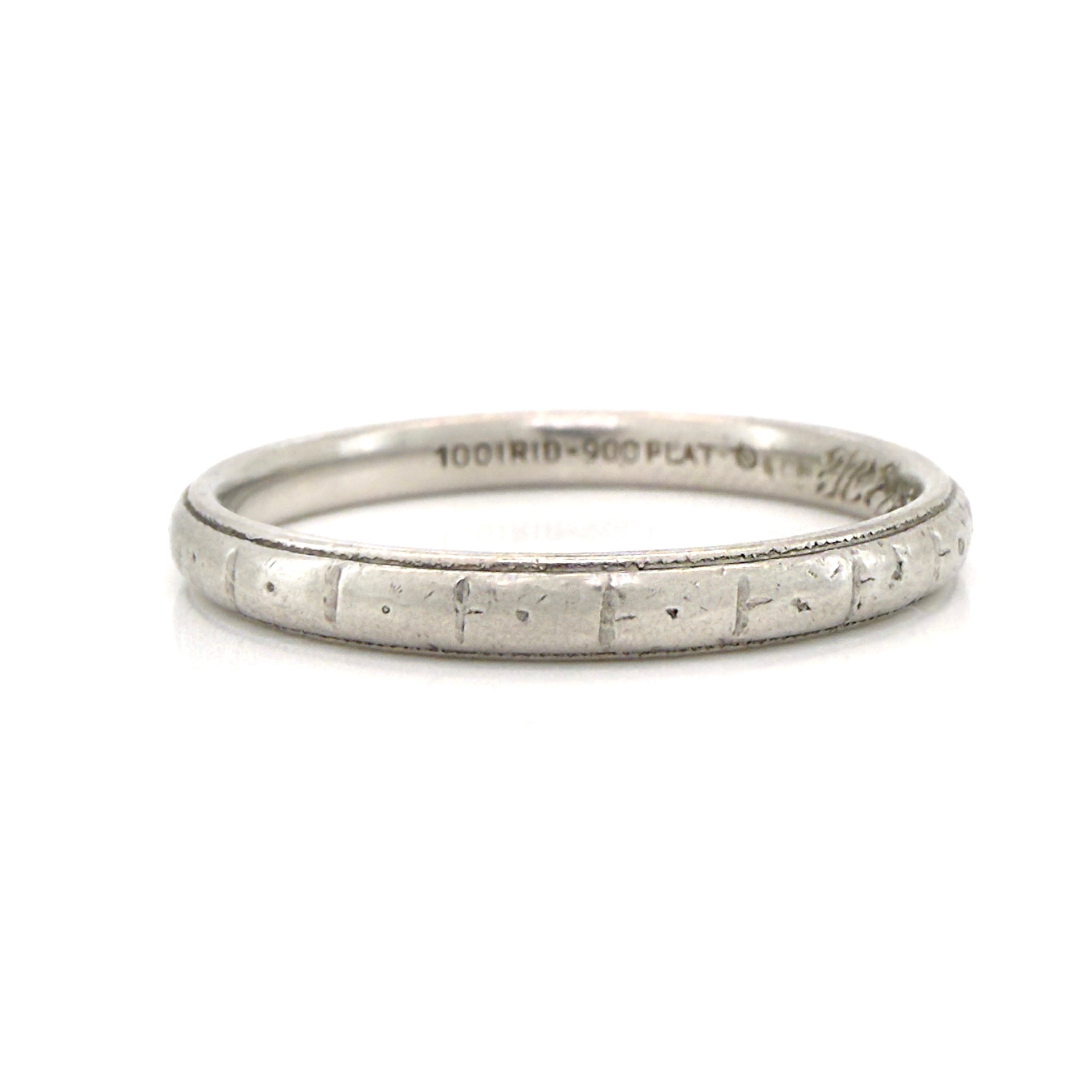 Art Deco platinum ring with textured design on a white background