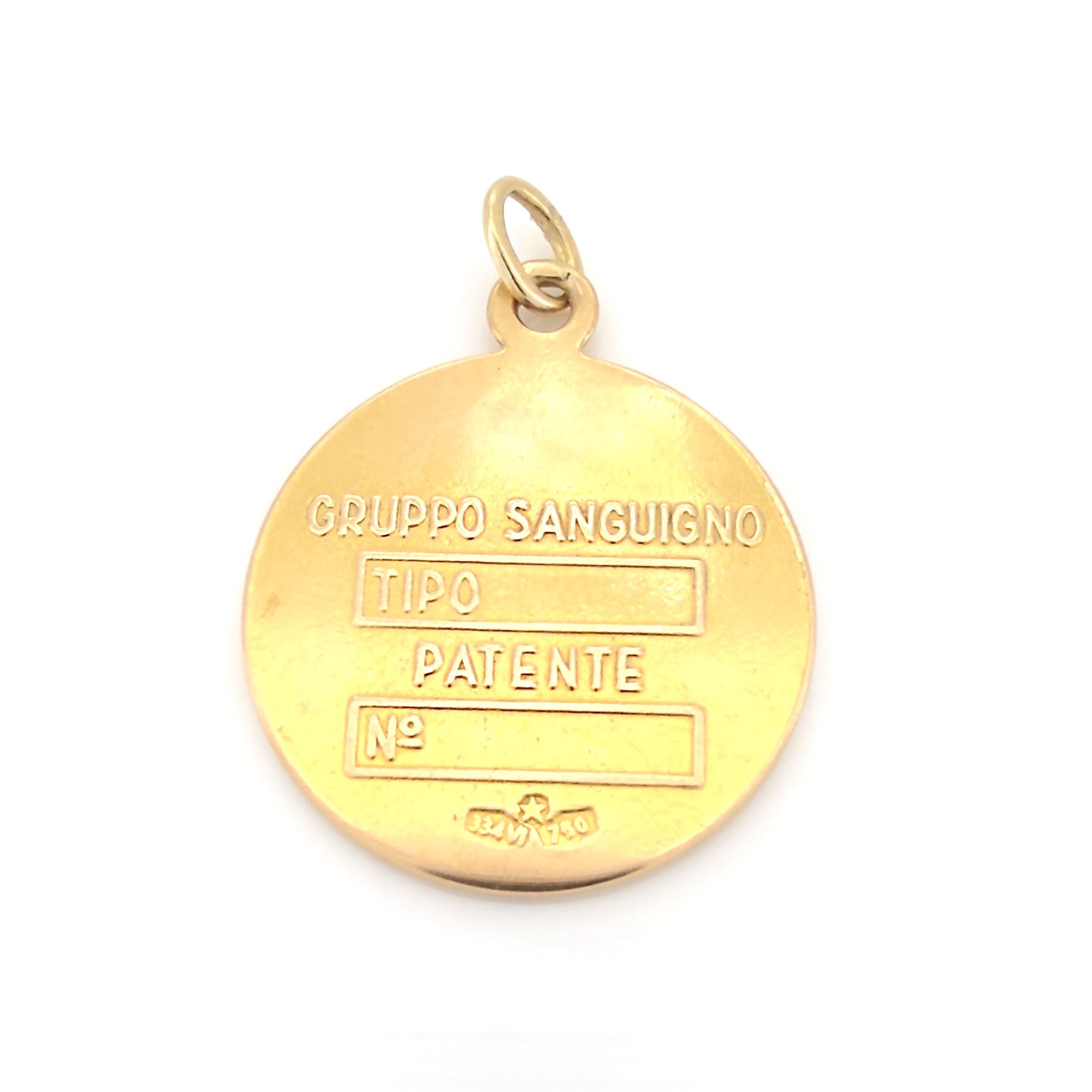 Vintage Ggold pendant with engraved text on a white background