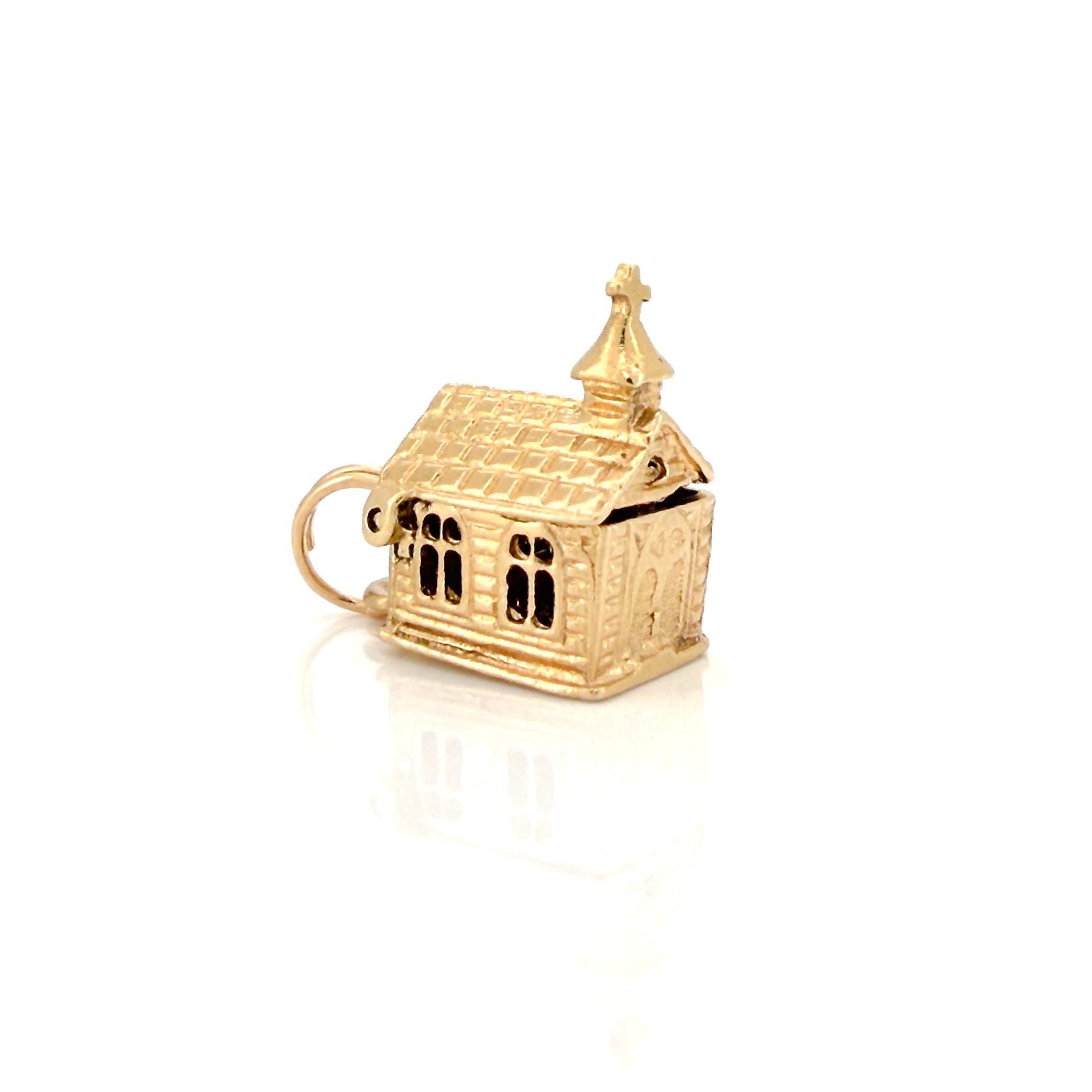 Vintage gold miniature chapel charm on a white background