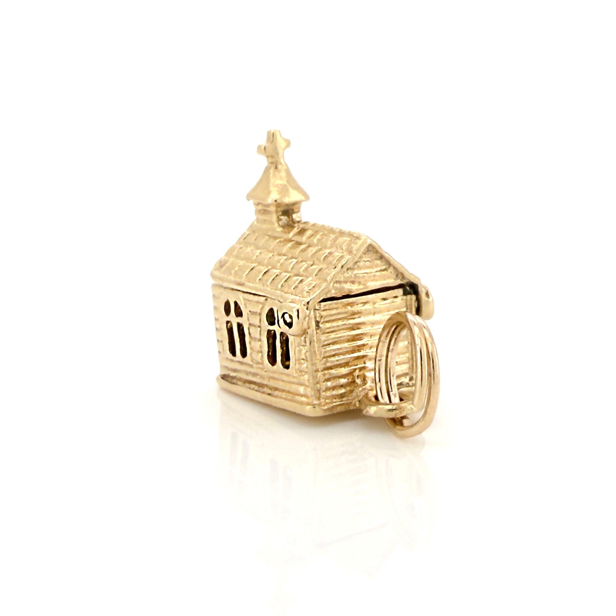 Vintage gold miniature chapel charm on a white background