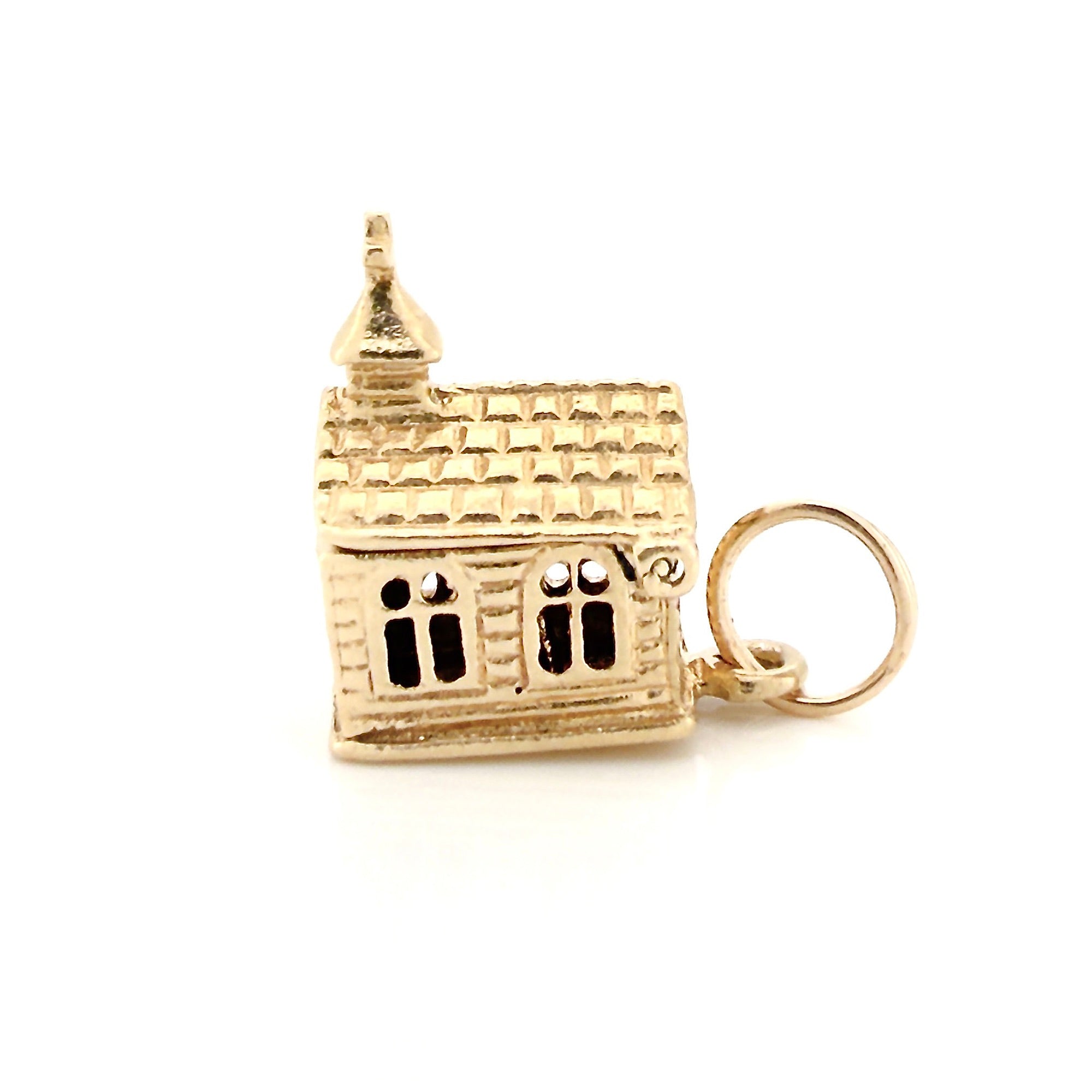 Vintage gold miniature chapel charm on a white background