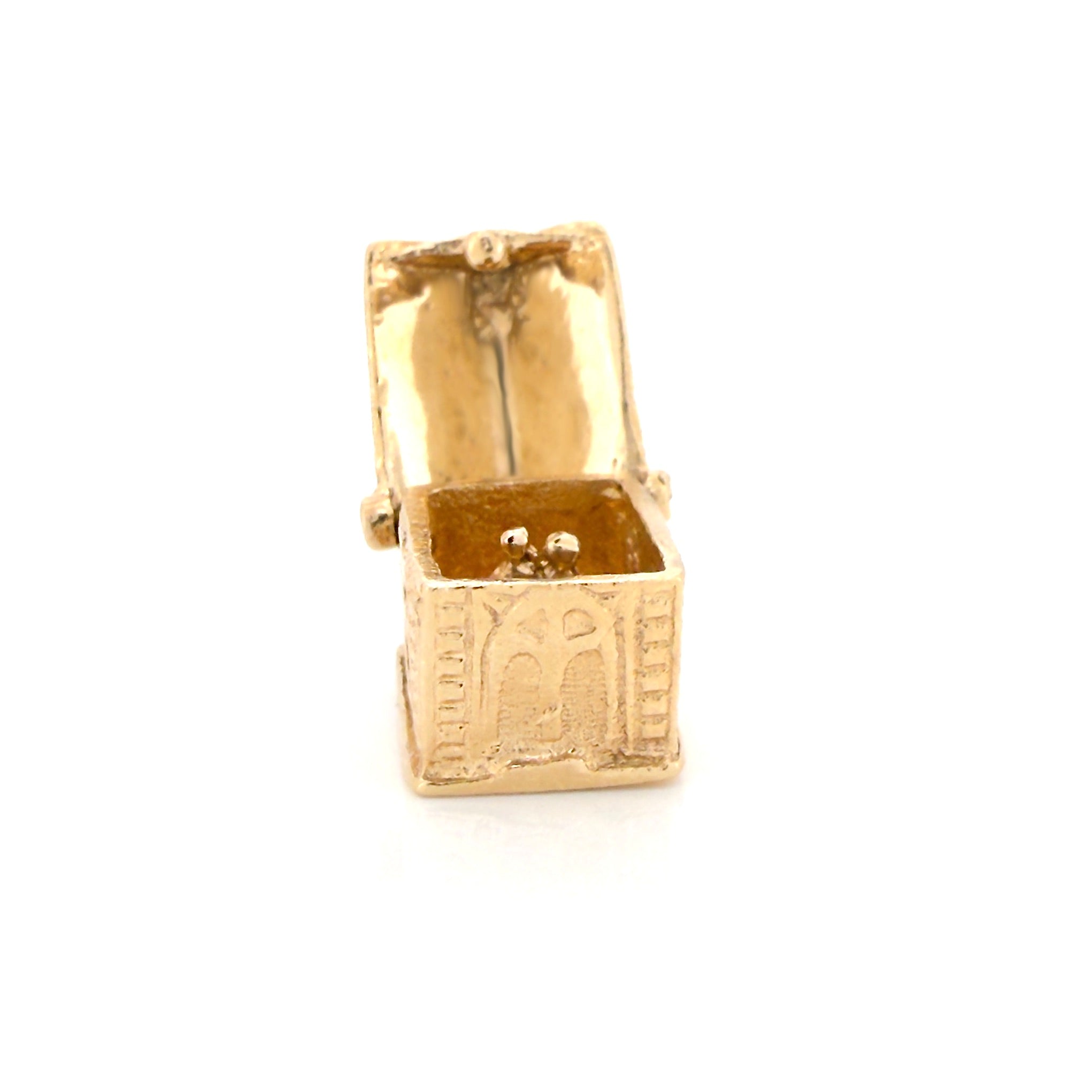 Vintage gold miniature chapel charm with a couple inside on a white background