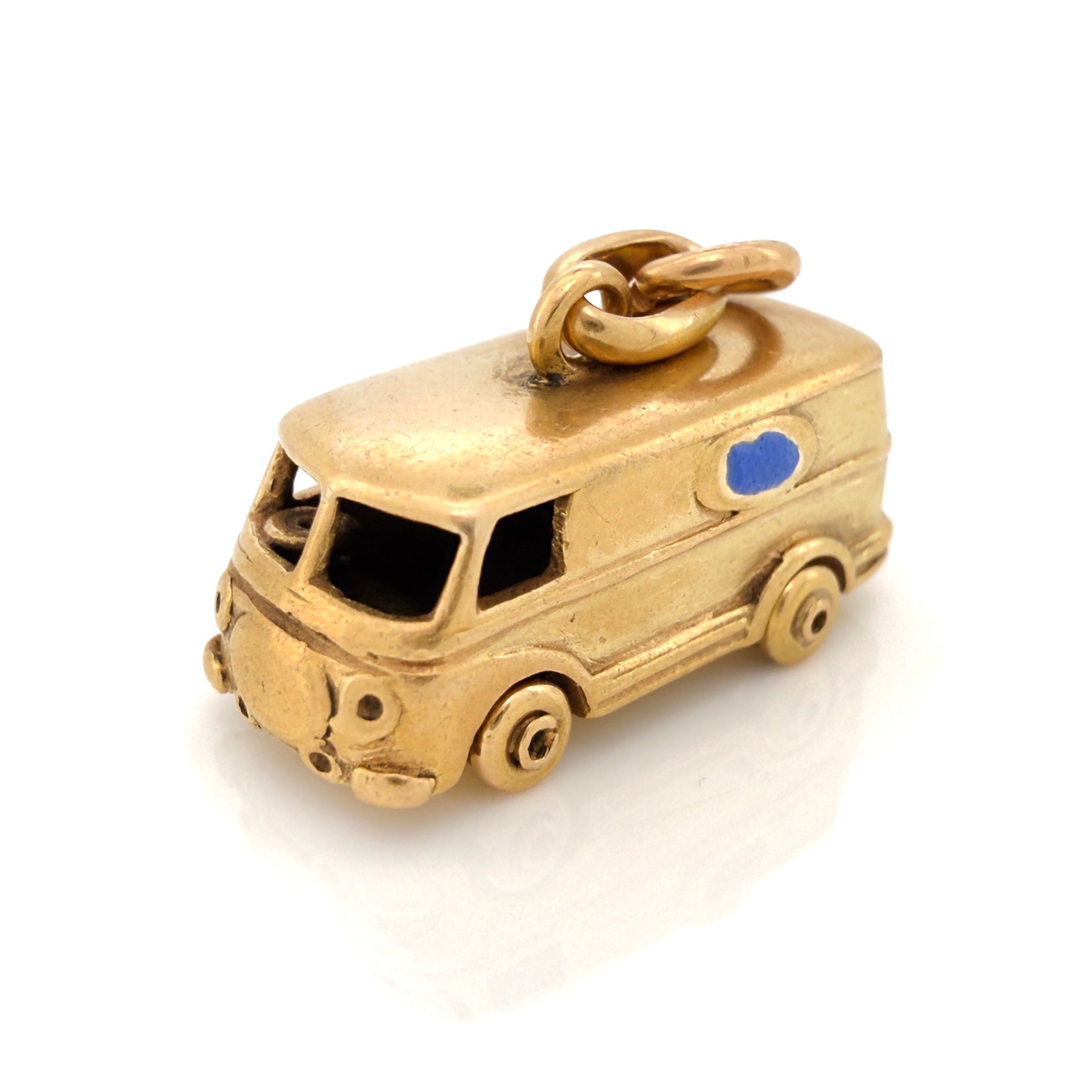 Vintage gold microbus  charm with a light blue enamel window on a white background