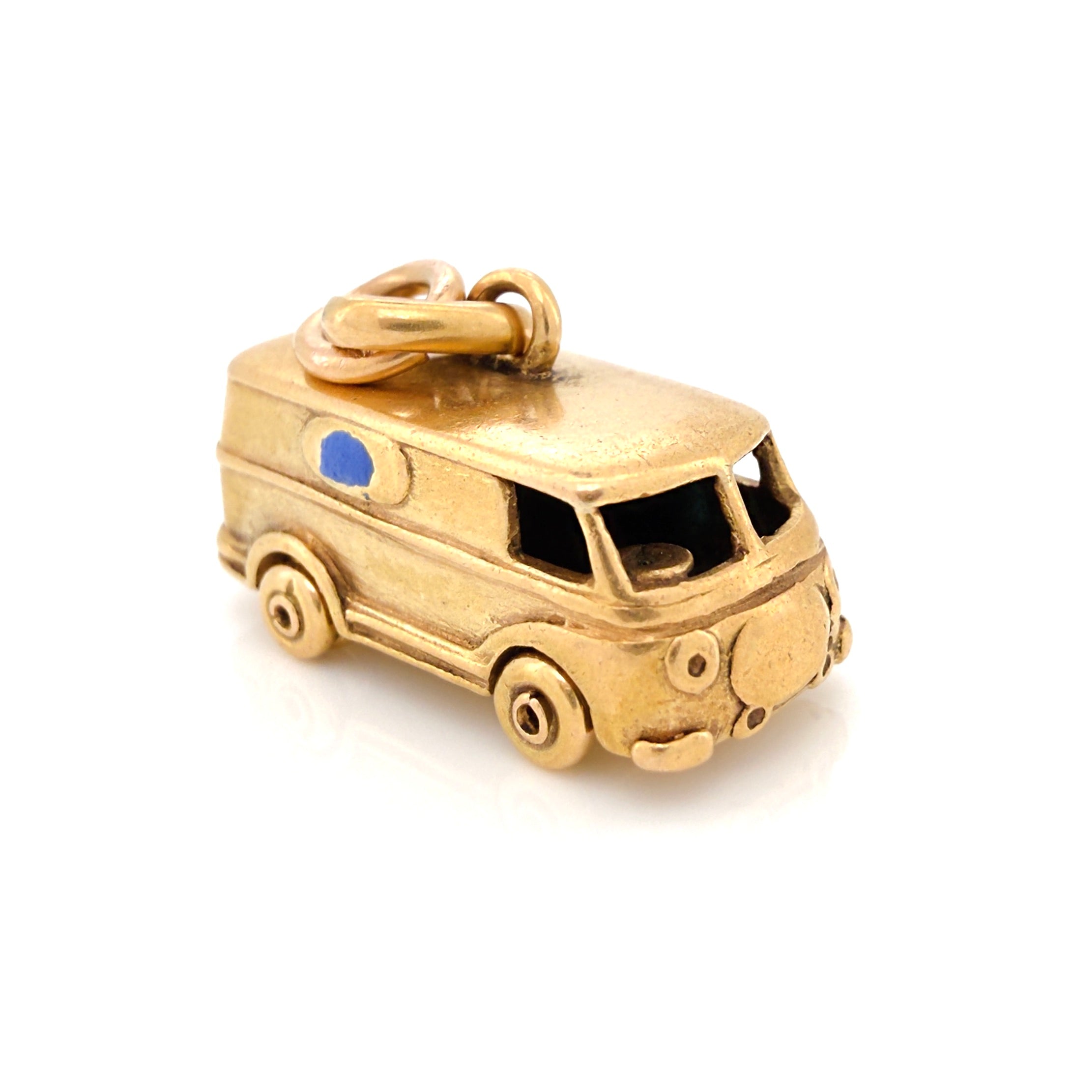 Vintage gold microbus charm with a light blue enamel window on a white background