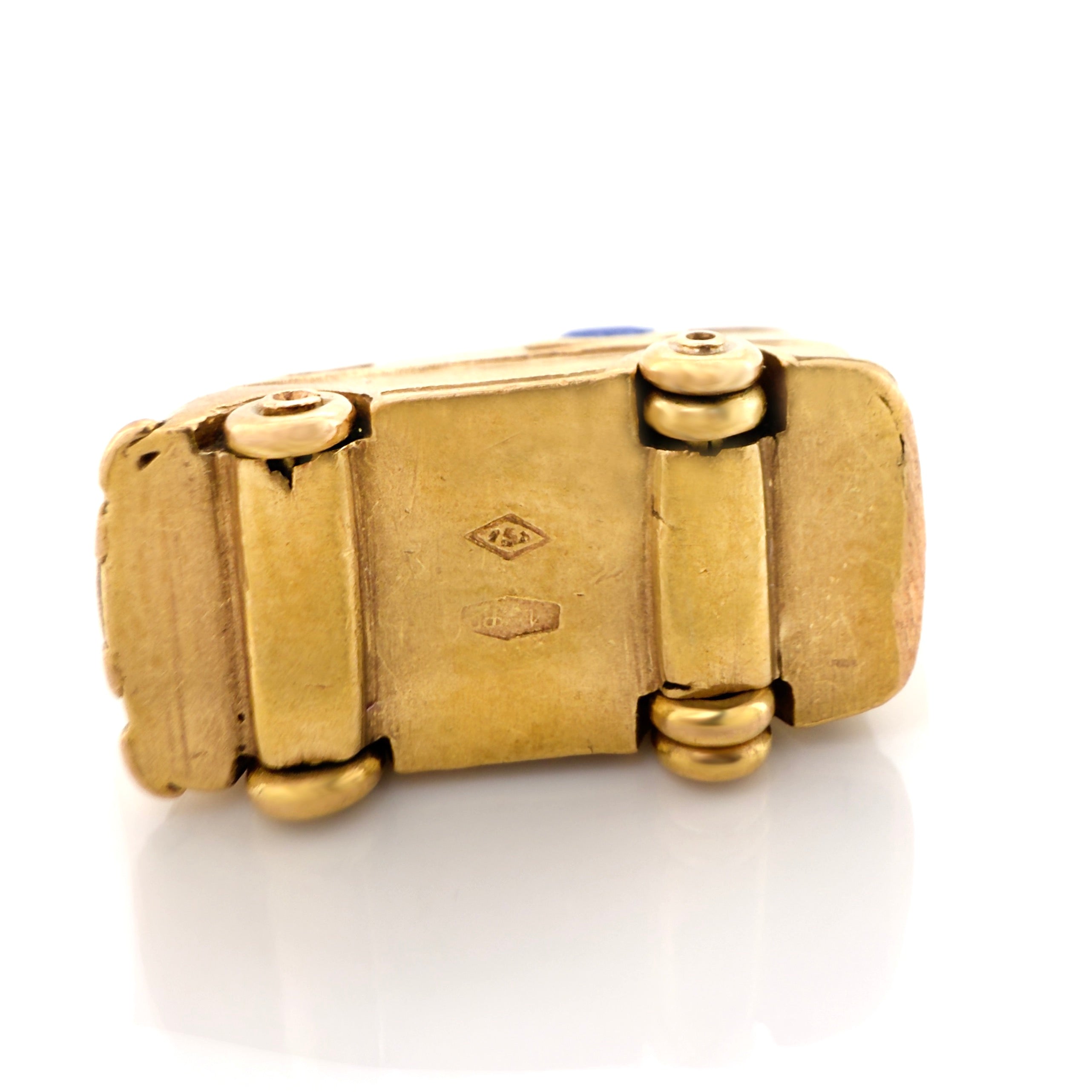 Bottom of a vintage gold microbus  charm with faint Italian hallmarks on a white background