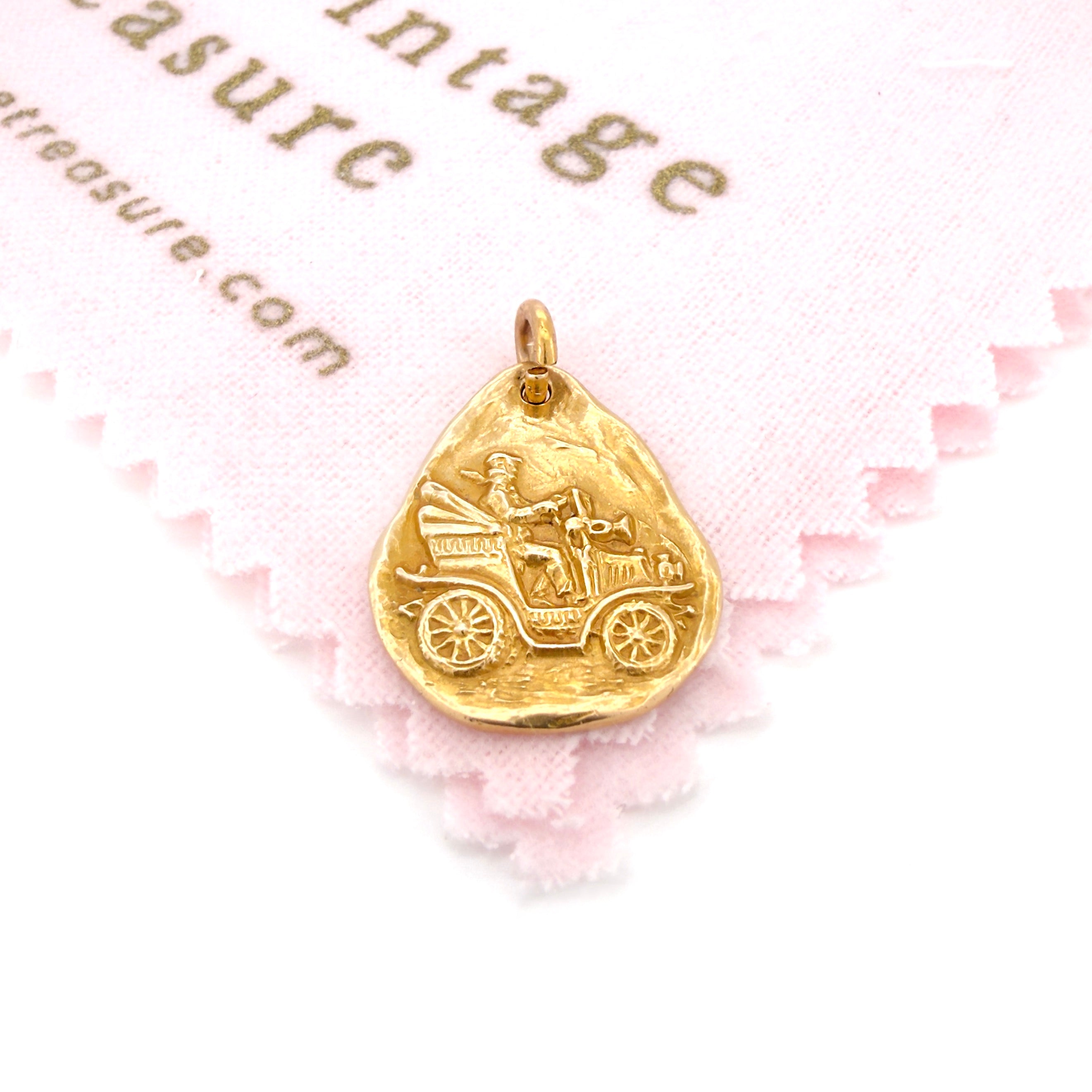 Gold pendant with a design on a pink background with 'Vintage Treasure' text.